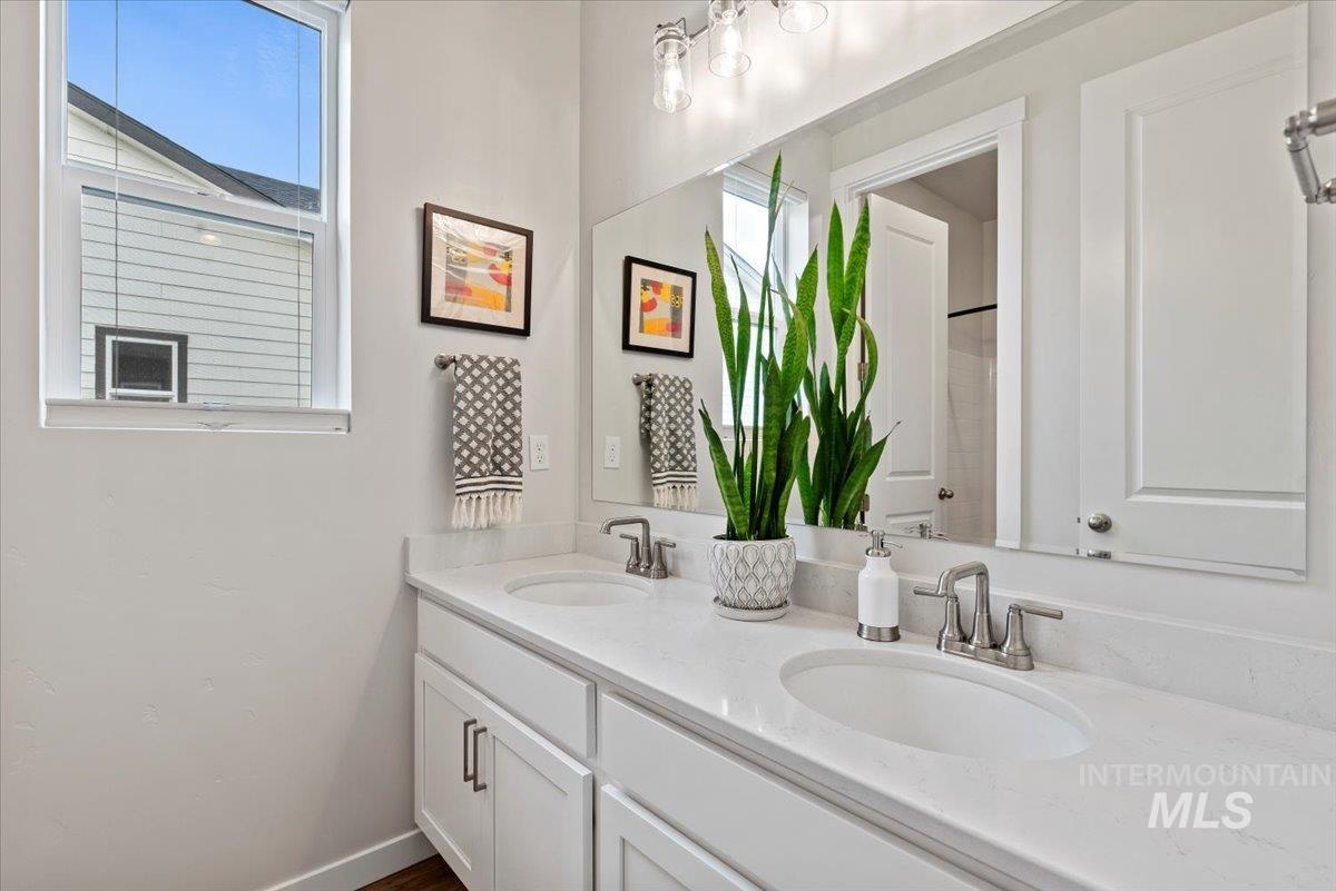 Bathroom with double vanity and a shower with curtain