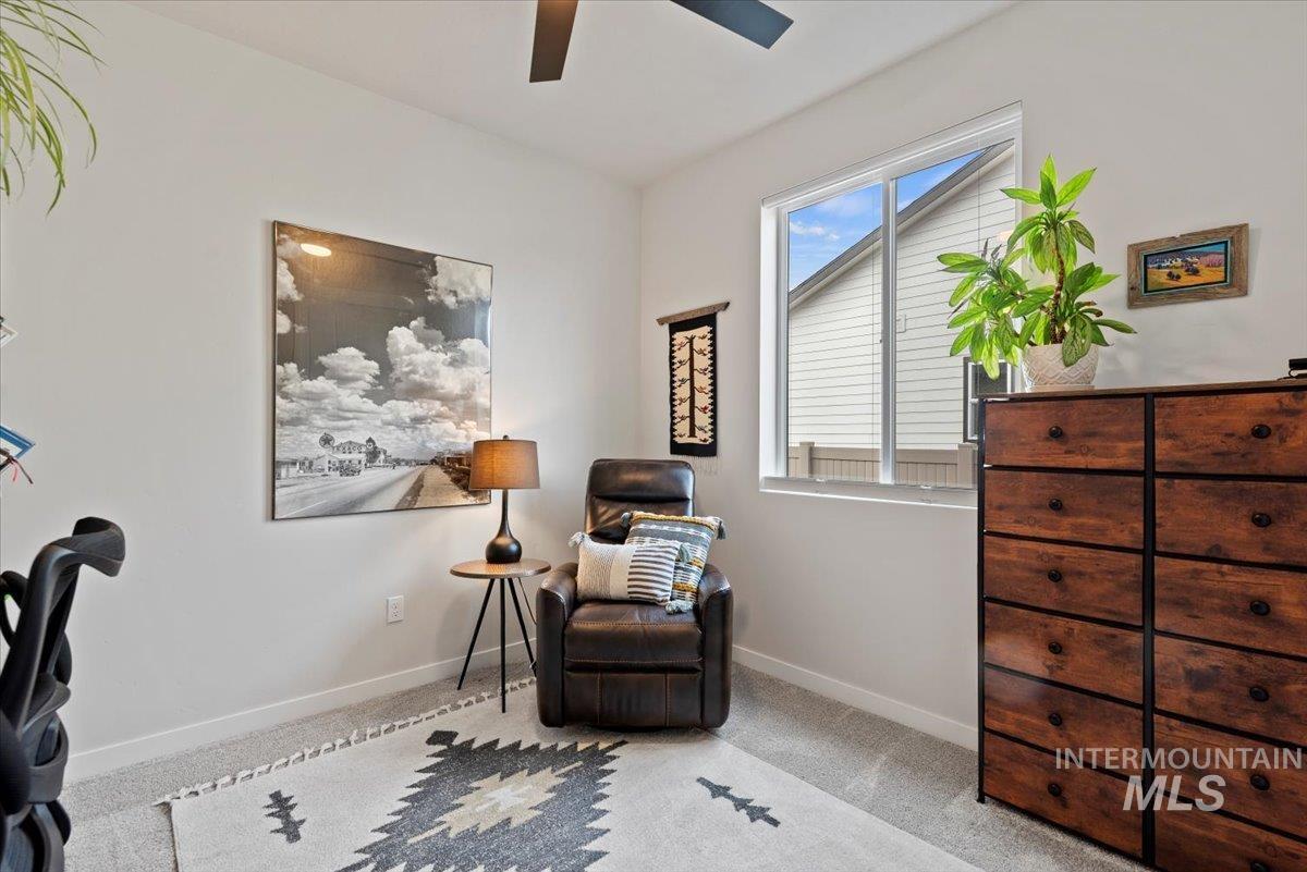Carpeted home office featuring baseboards