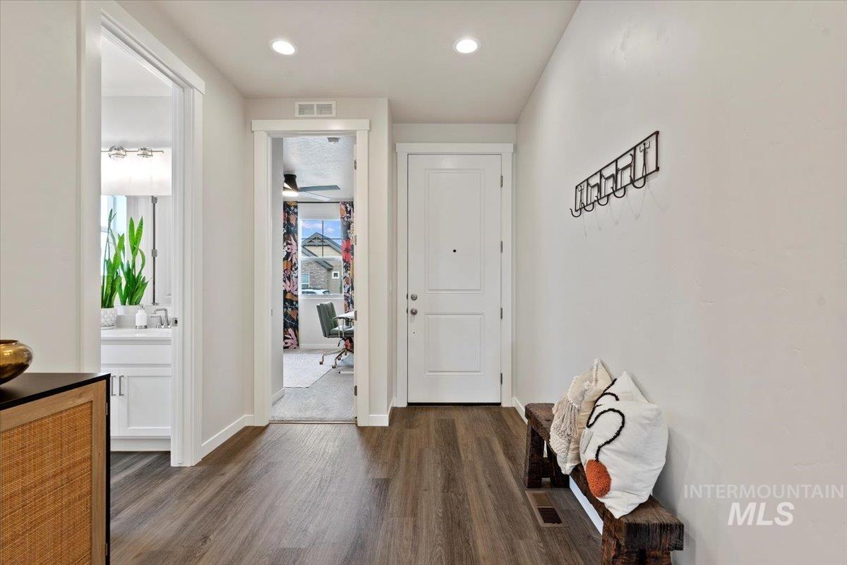 Hallway featuring dark wood finished floors and recessed lighting