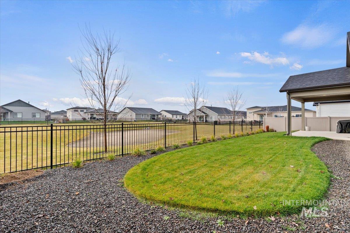 Fenced backyard with a residential view and a patio area