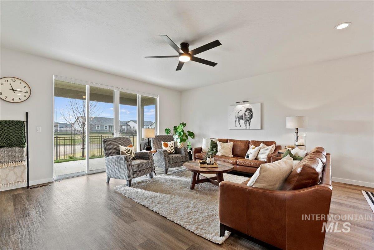 Living room with wood finished floors and a ceiling fan
