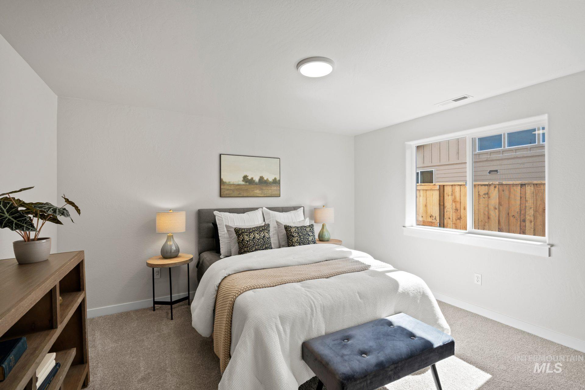 Carpeted bedroom featuring baseboards