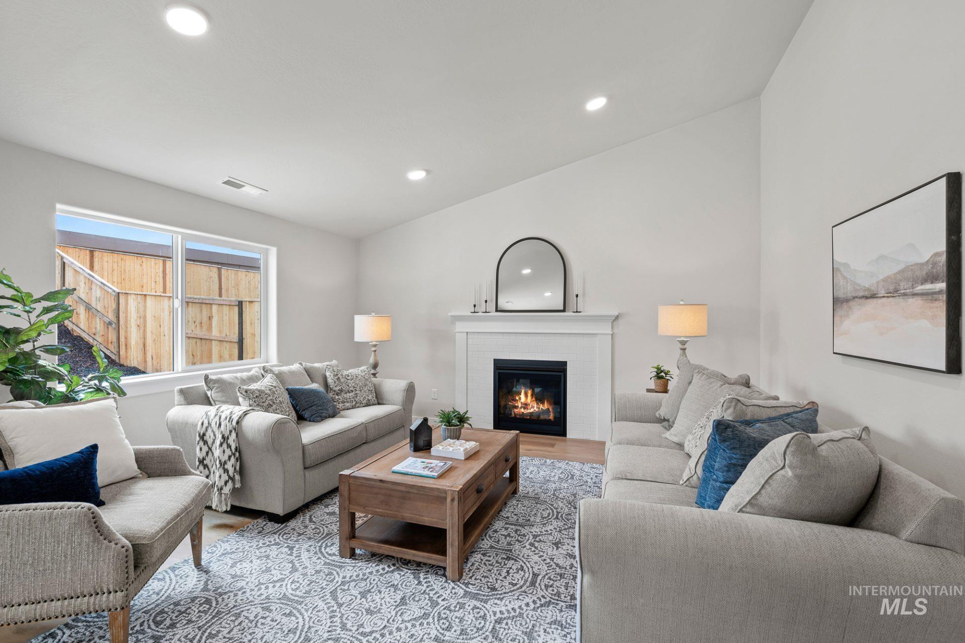 Living area featuring recessed lighting, a glass covered fireplace, and light wood-style flooring