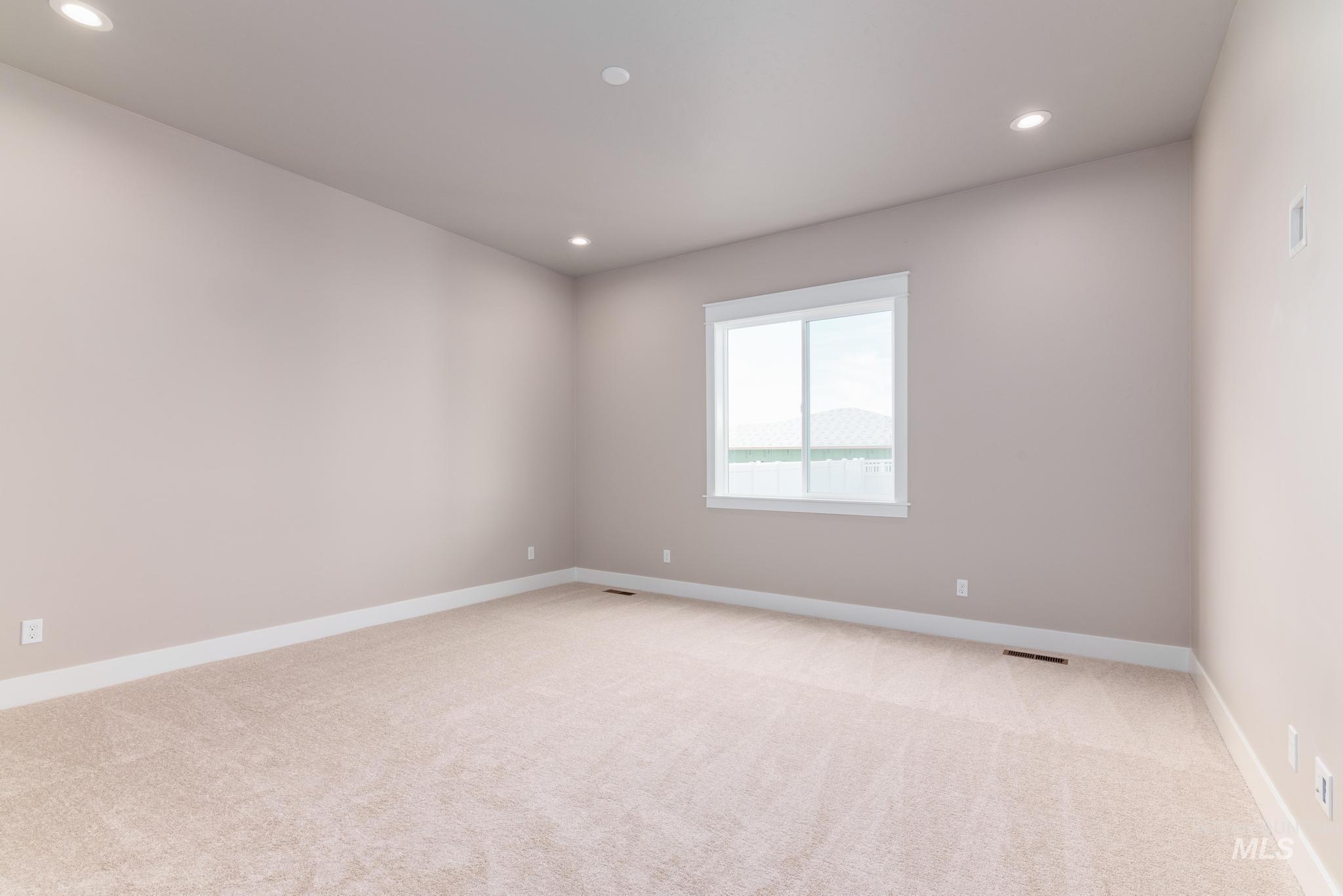 Unfurnished room featuring recessed lighting and light carpet