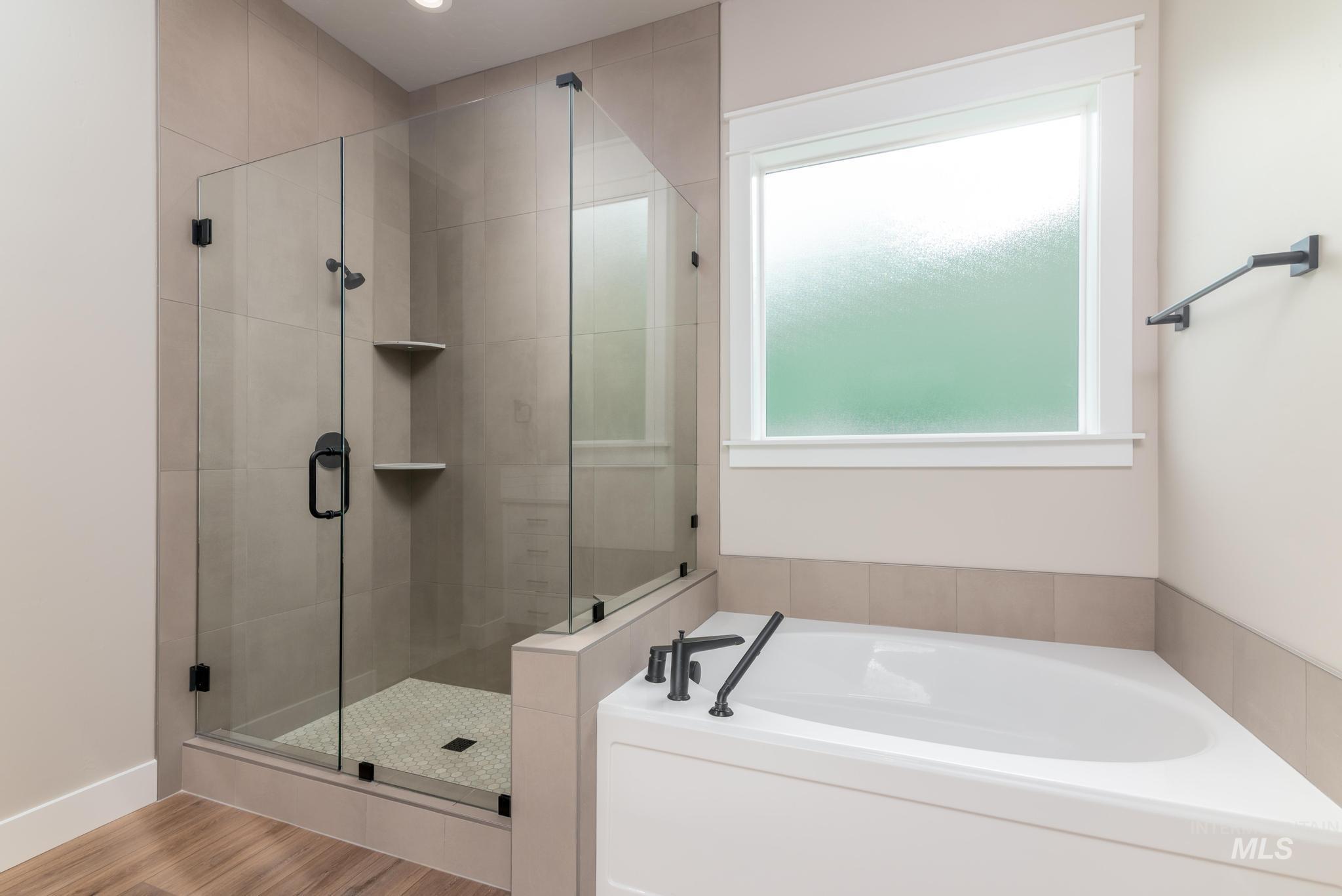 Bathroom with a garden tub and a shower stall