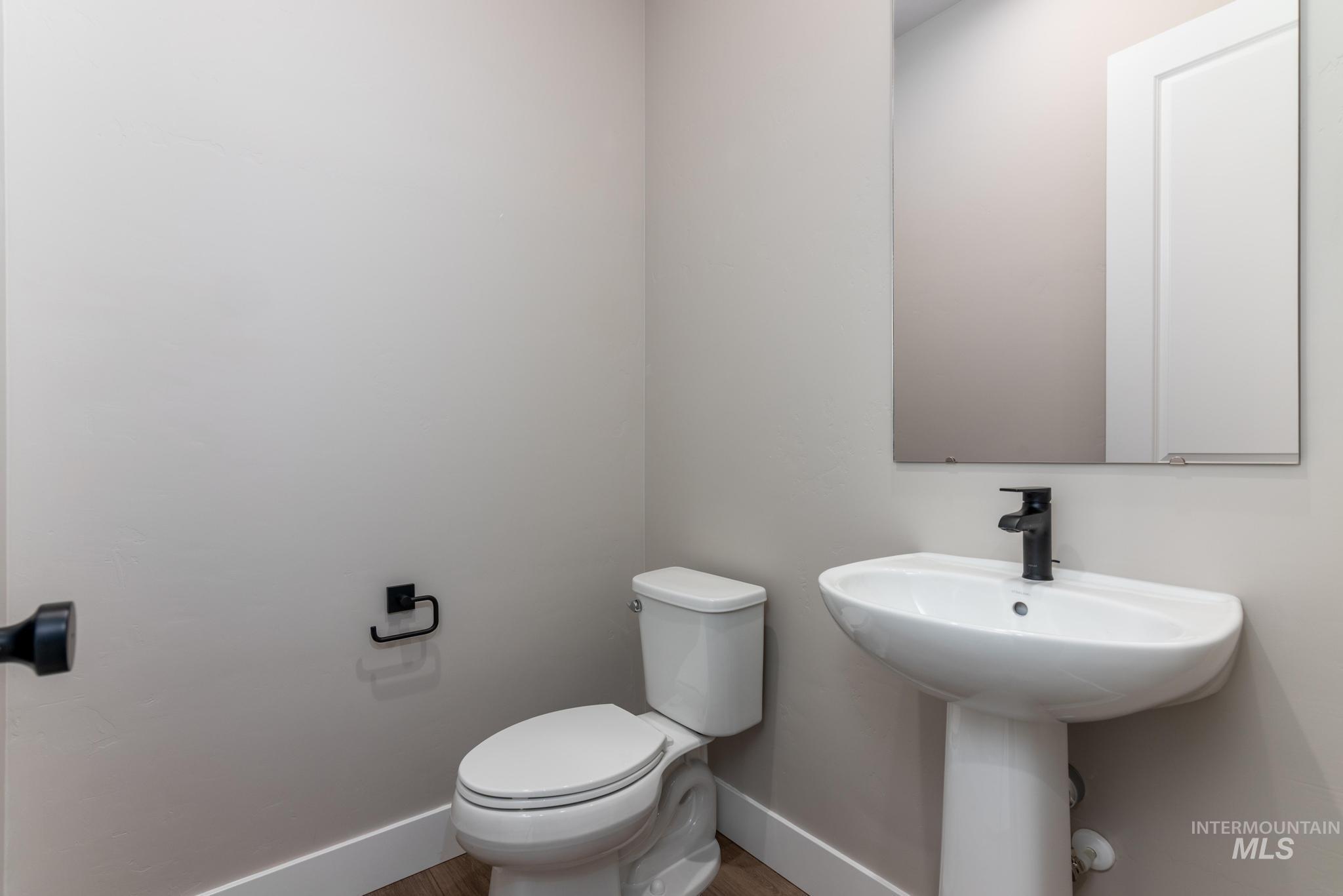 Bathroom with baseboards and wood finished floors