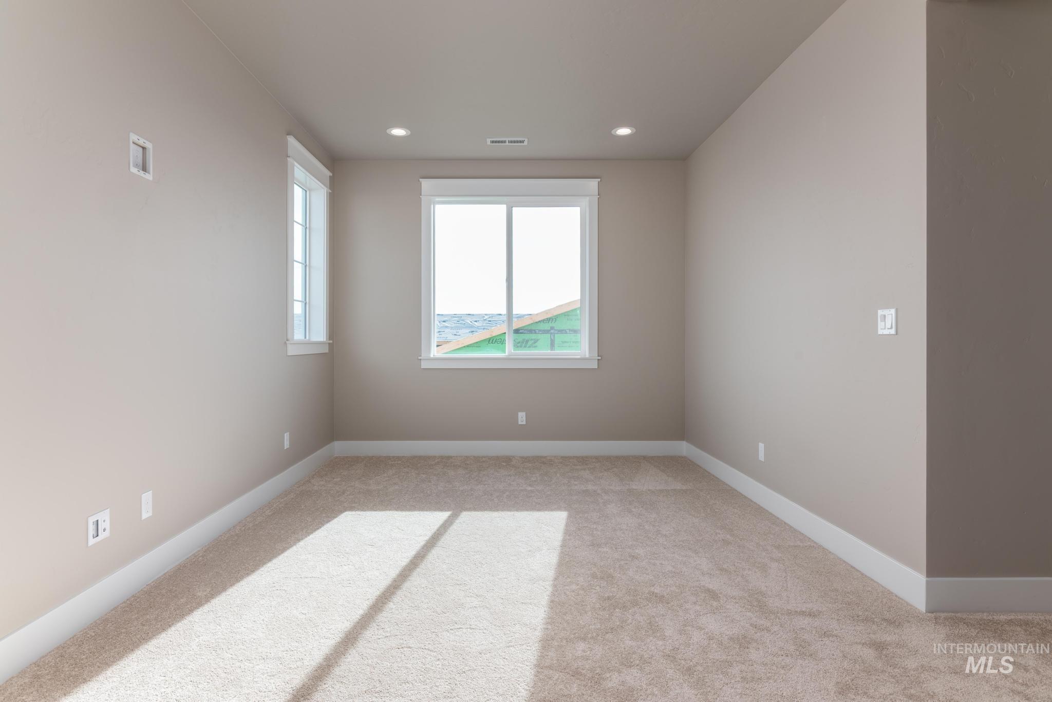 Spare room featuring light carpet and recessed lighting
