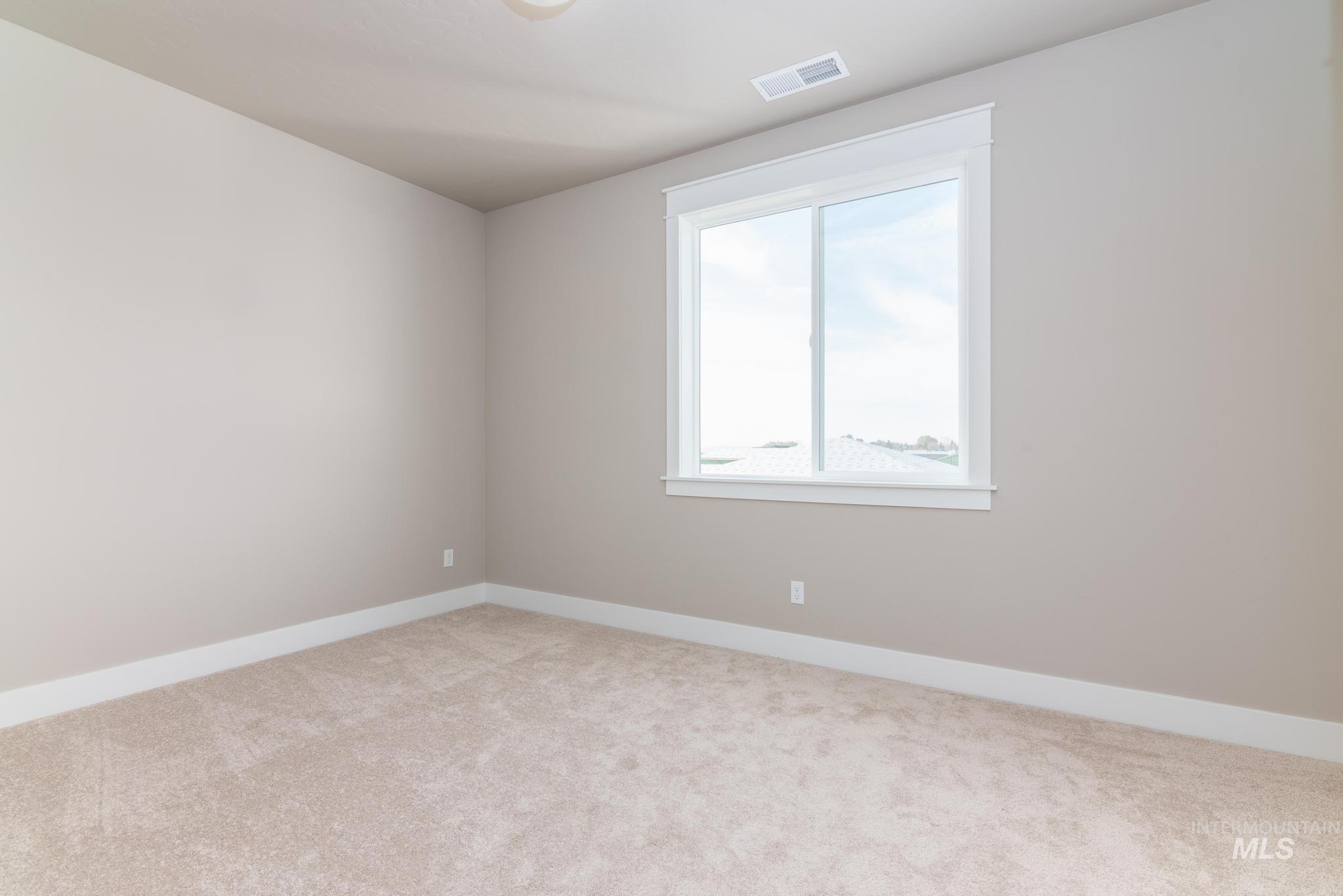 Unfurnished room with baseboards and light carpet