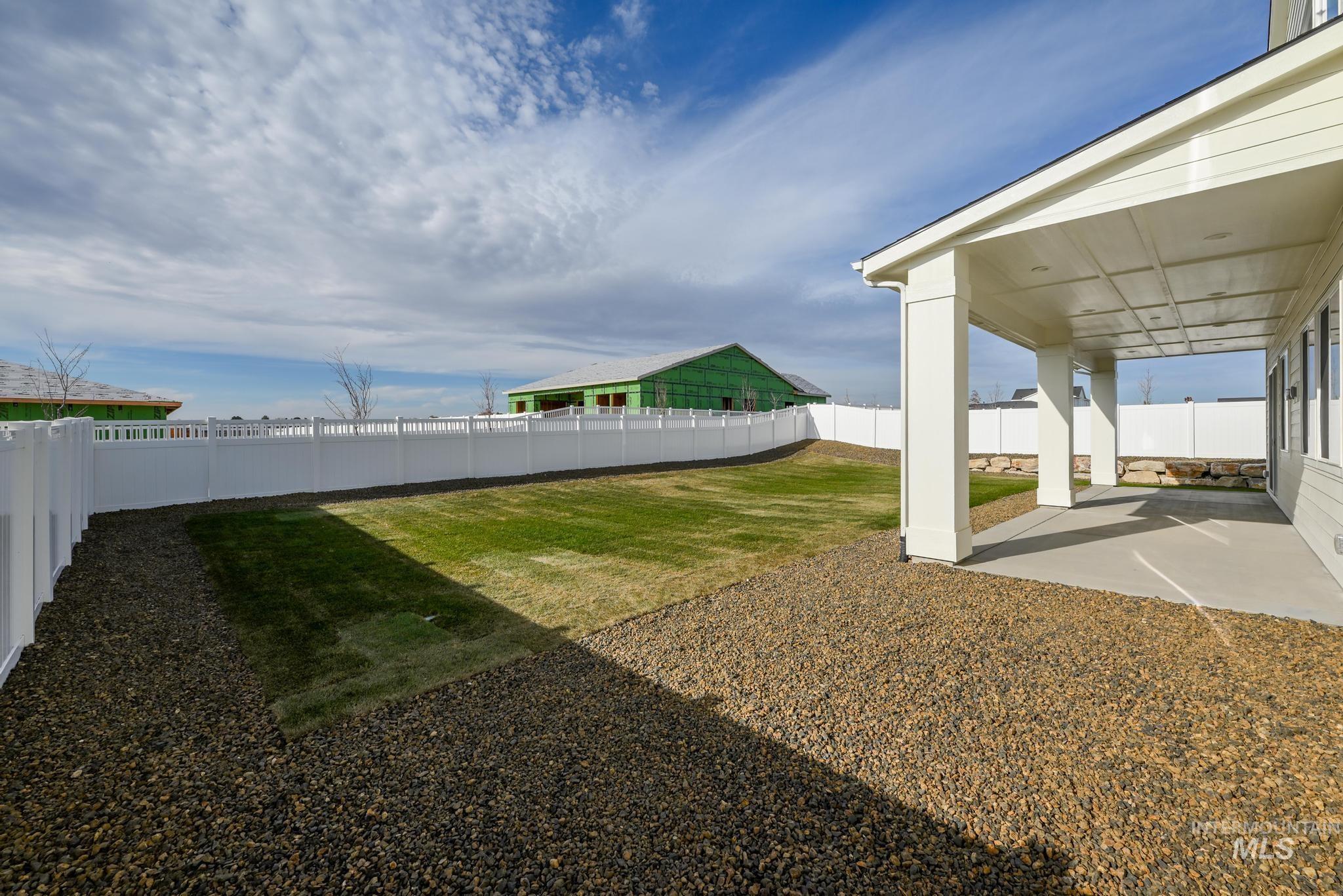 Fenced backyard with a patio area
