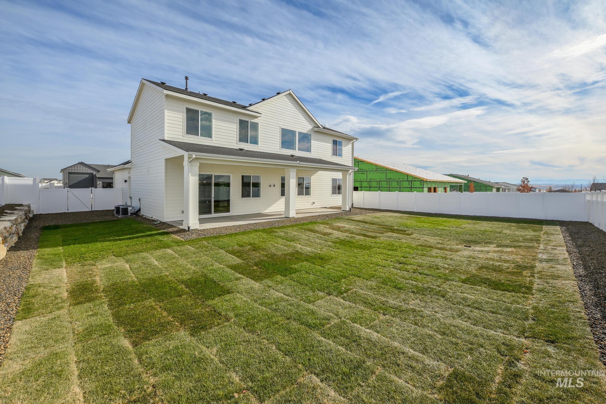 Rear view of property with a patio area and a fenced backyard