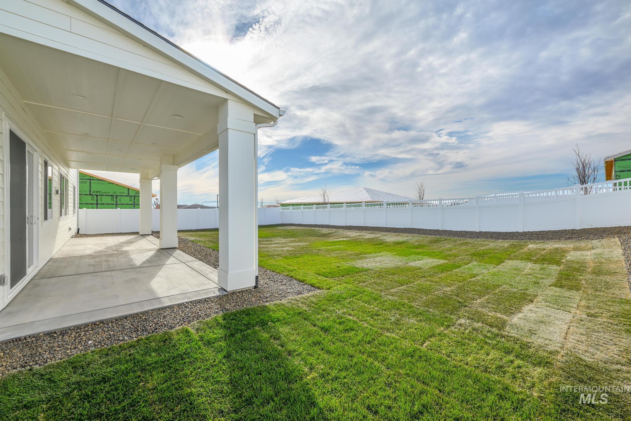 Fenced backyard with a patio area