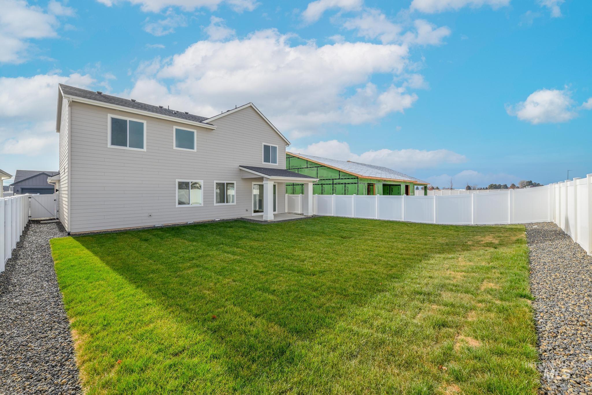 Rear view of property with a patio area and a fenced backyard