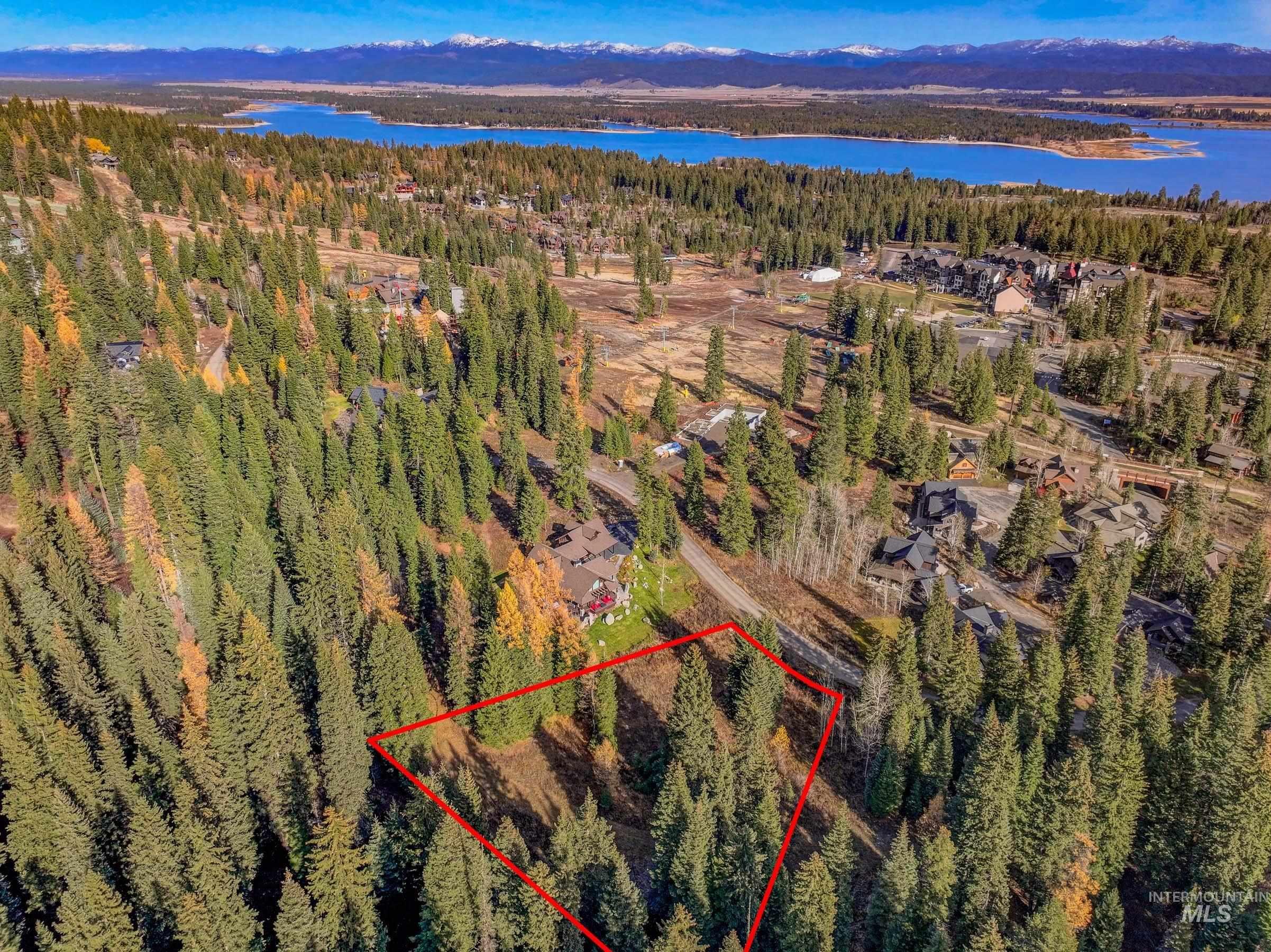 Aerial overview of property's location with property parcel outlined and a large body of water