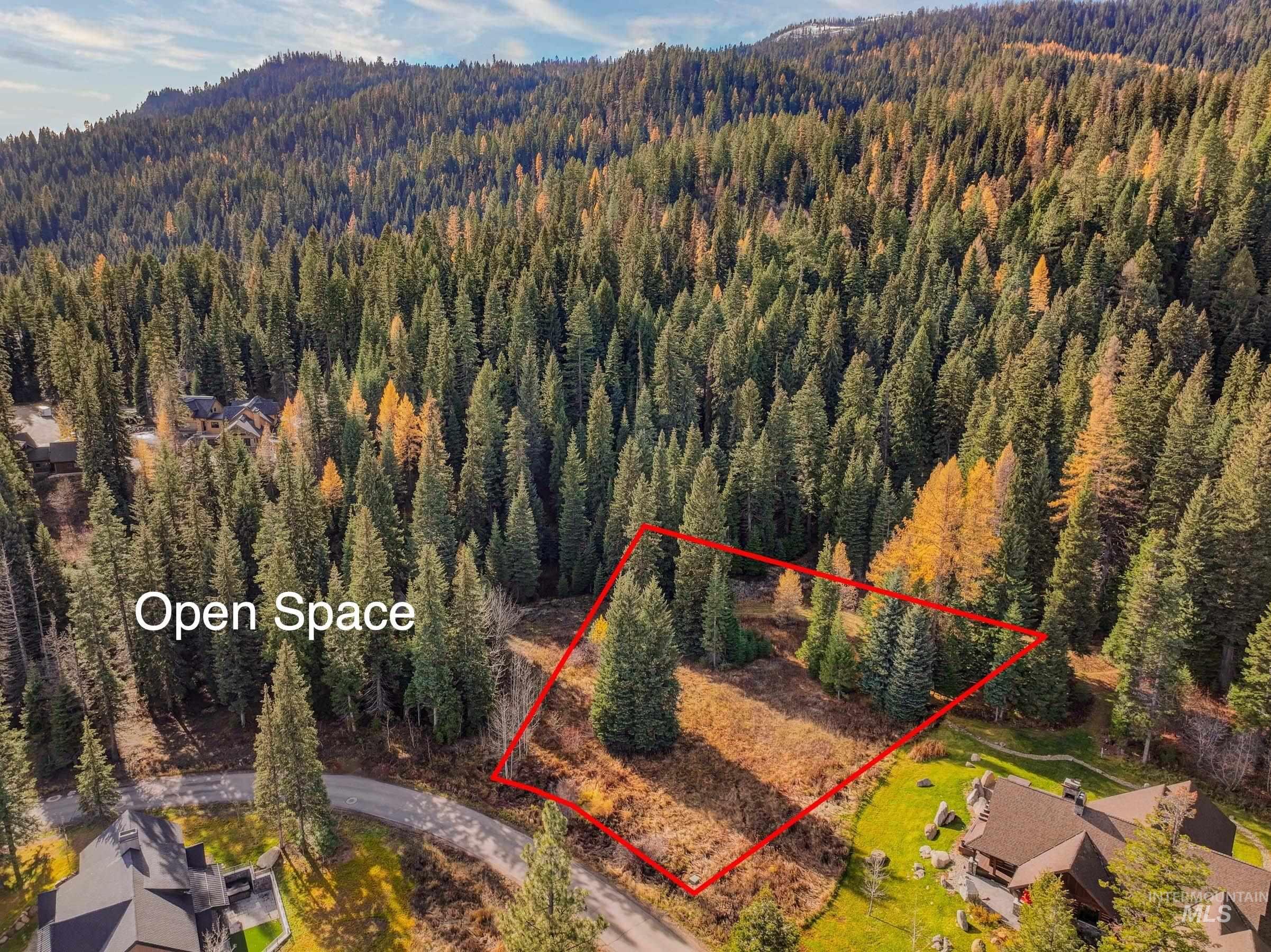 View of property location featuring property boundaries highlighted and a heavily wooded area