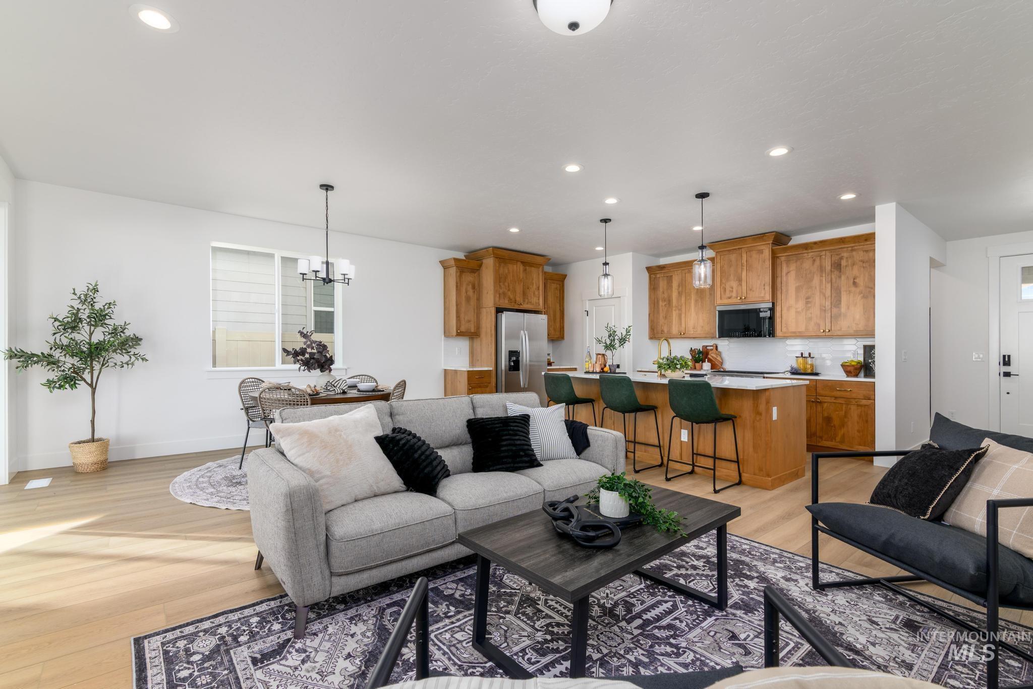 Living room featuring recessed lighting, a chandelier, and light wood-type flooring