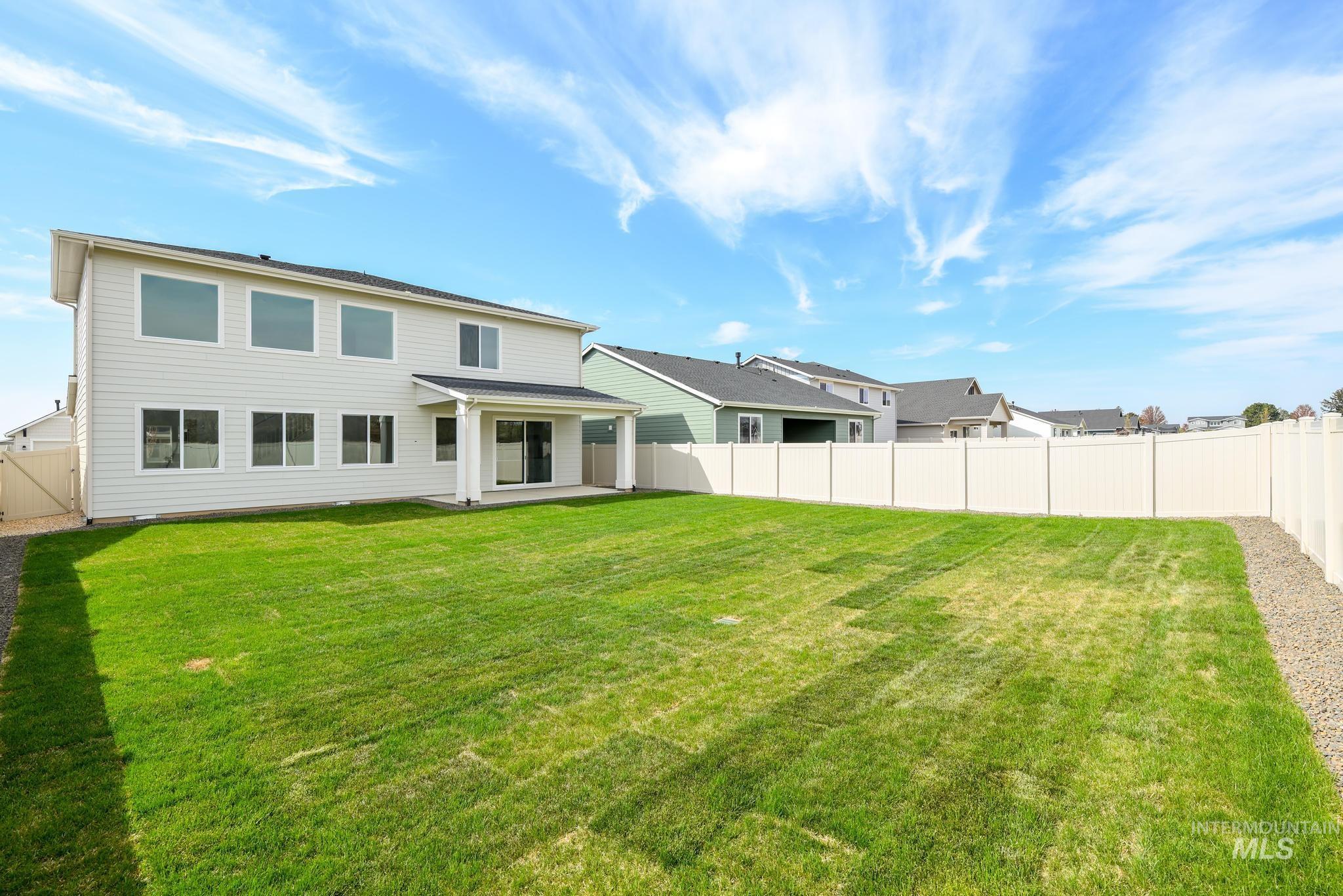 Rear view of house with a patio, a fenced backyard, and a residential view