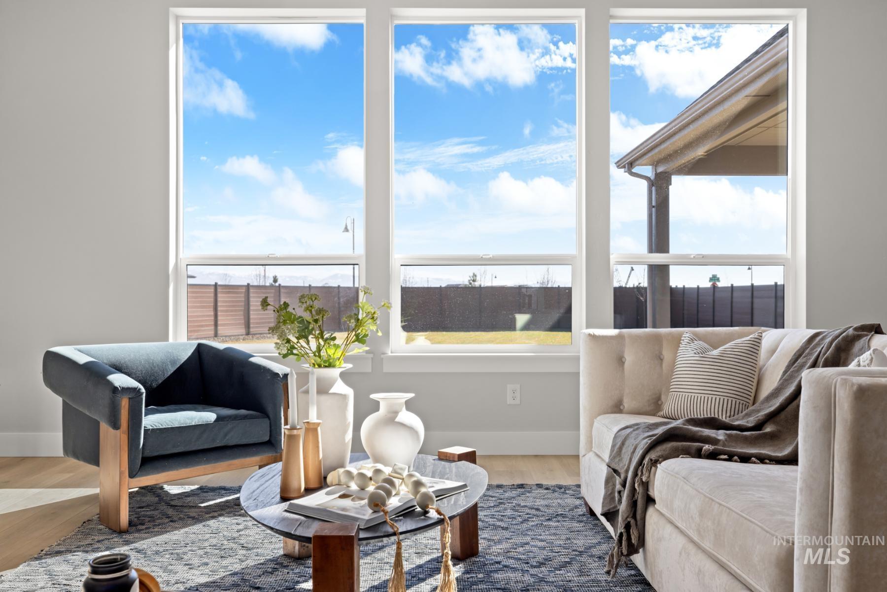 Sitting room featuring plenty of natural light and wood finished floors