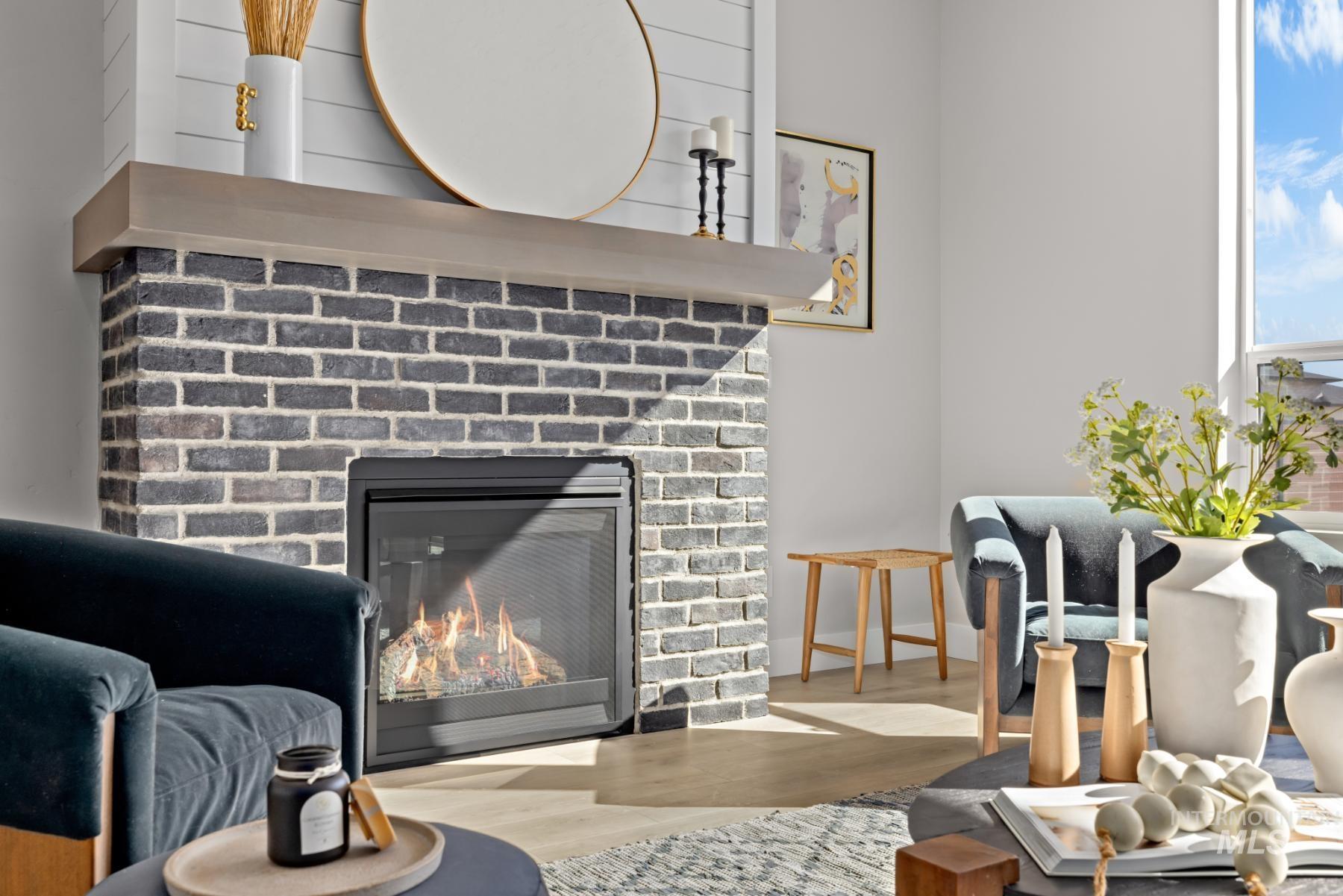 Detailed view of wood finished floors and a fireplace