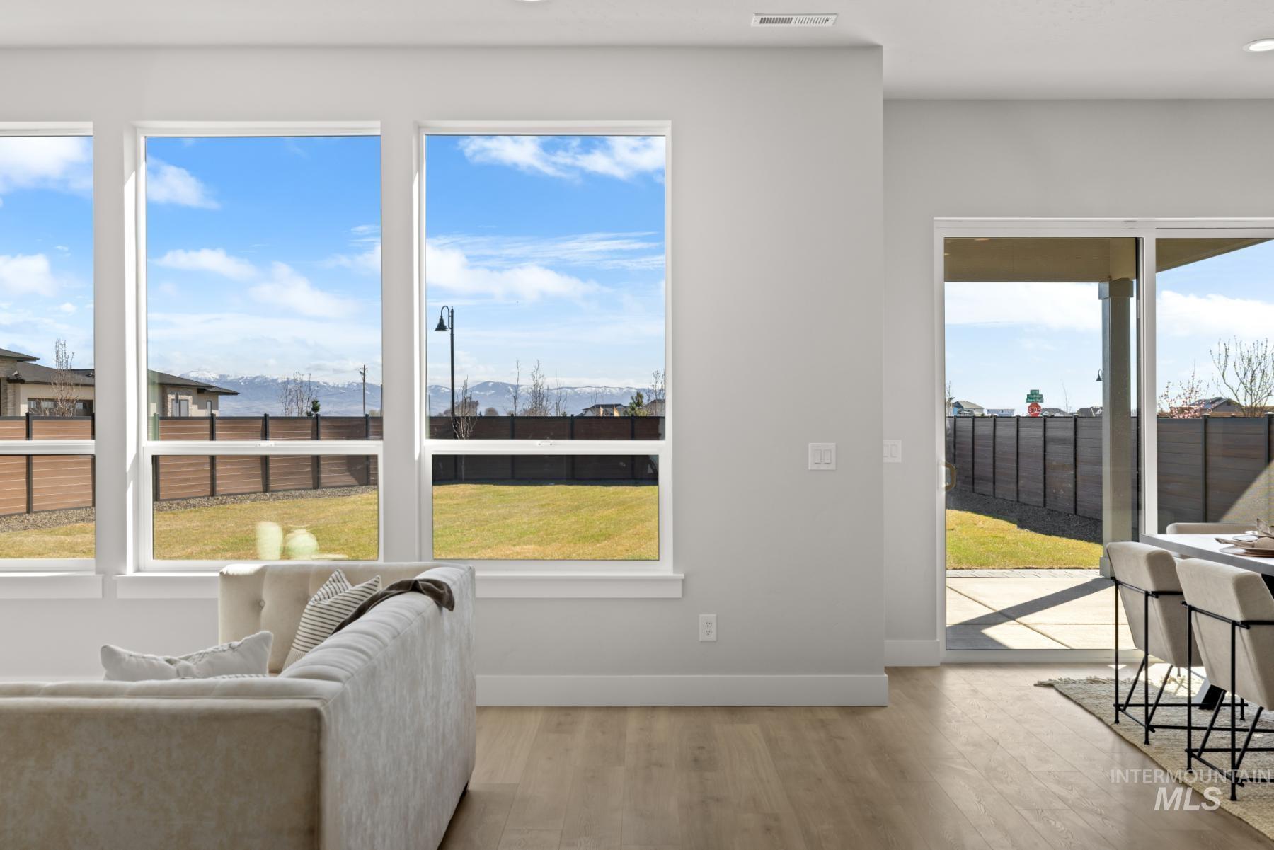Living area with light wood-style flooring and a mountain view