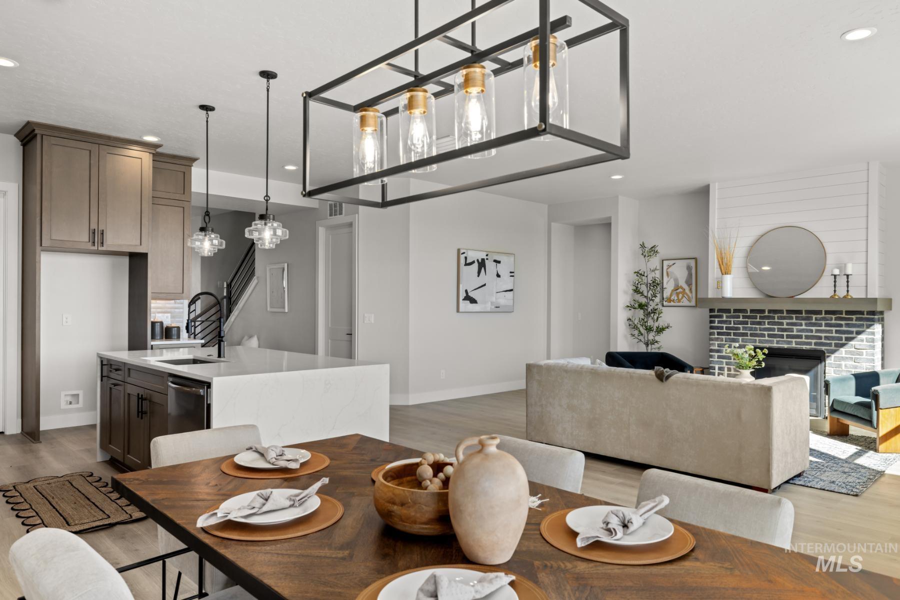 Dining room with recessed lighting, light wood-type flooring, and a fireplace