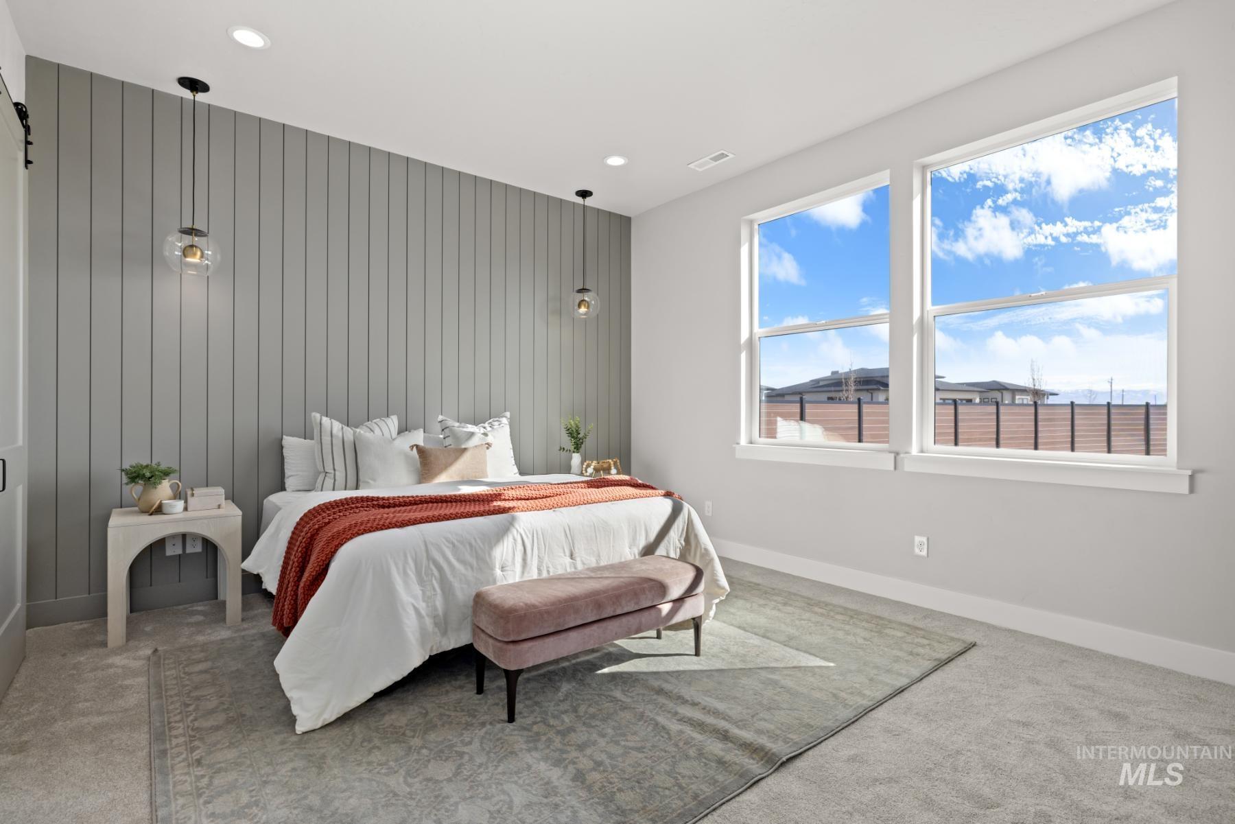 Bedroom featuring carpet floors, recessed lighting, and wooden walls