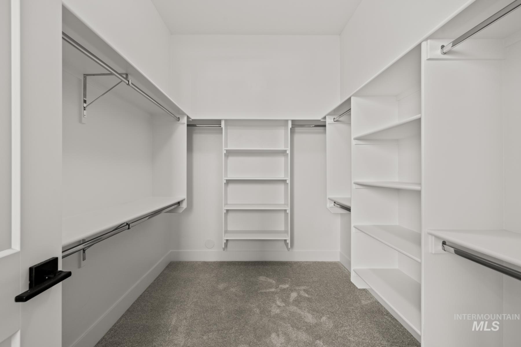 Walk in closet with dark carpet