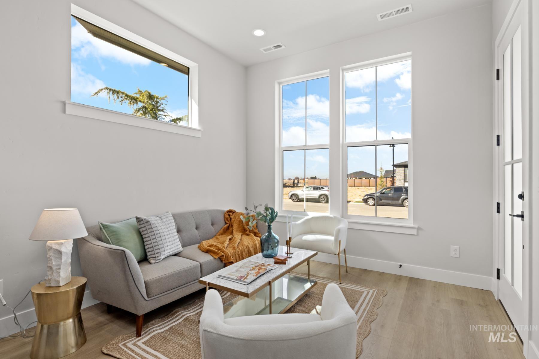 Living room with light wood-style floors and recessed lighting