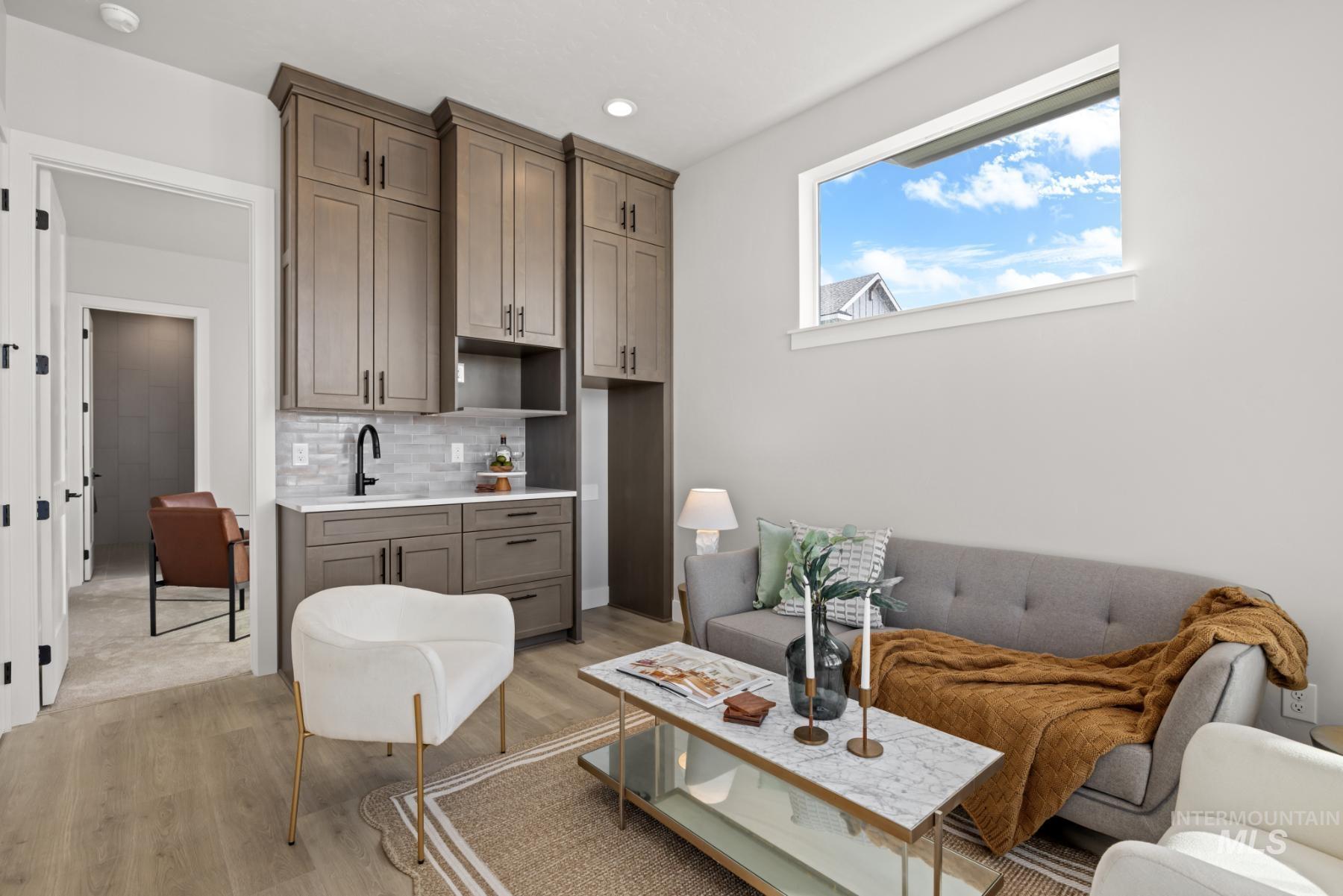 Living area featuring light wood-style floors and recessed lighting