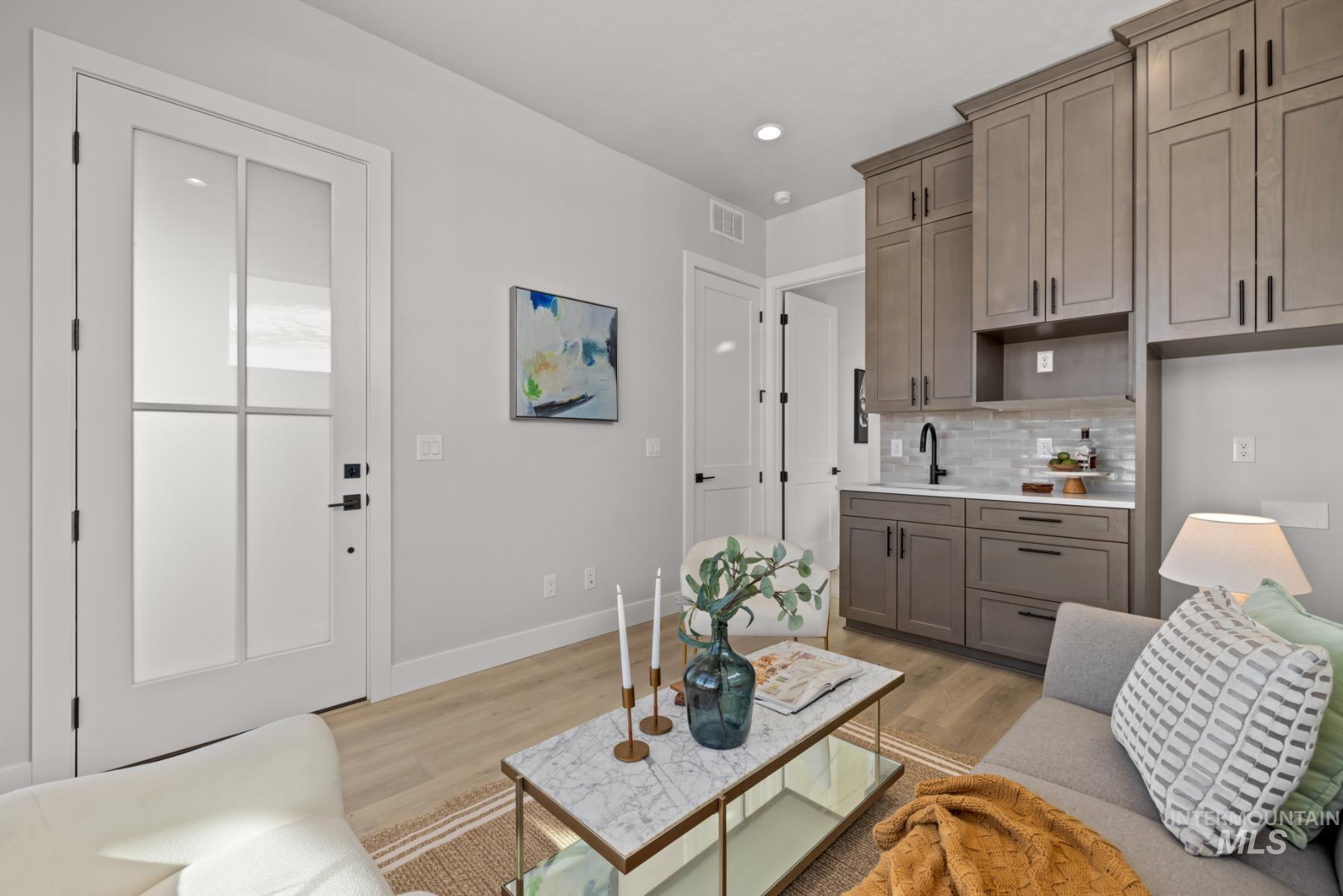 Living area featuring light wood-style flooring and recessed lighting
