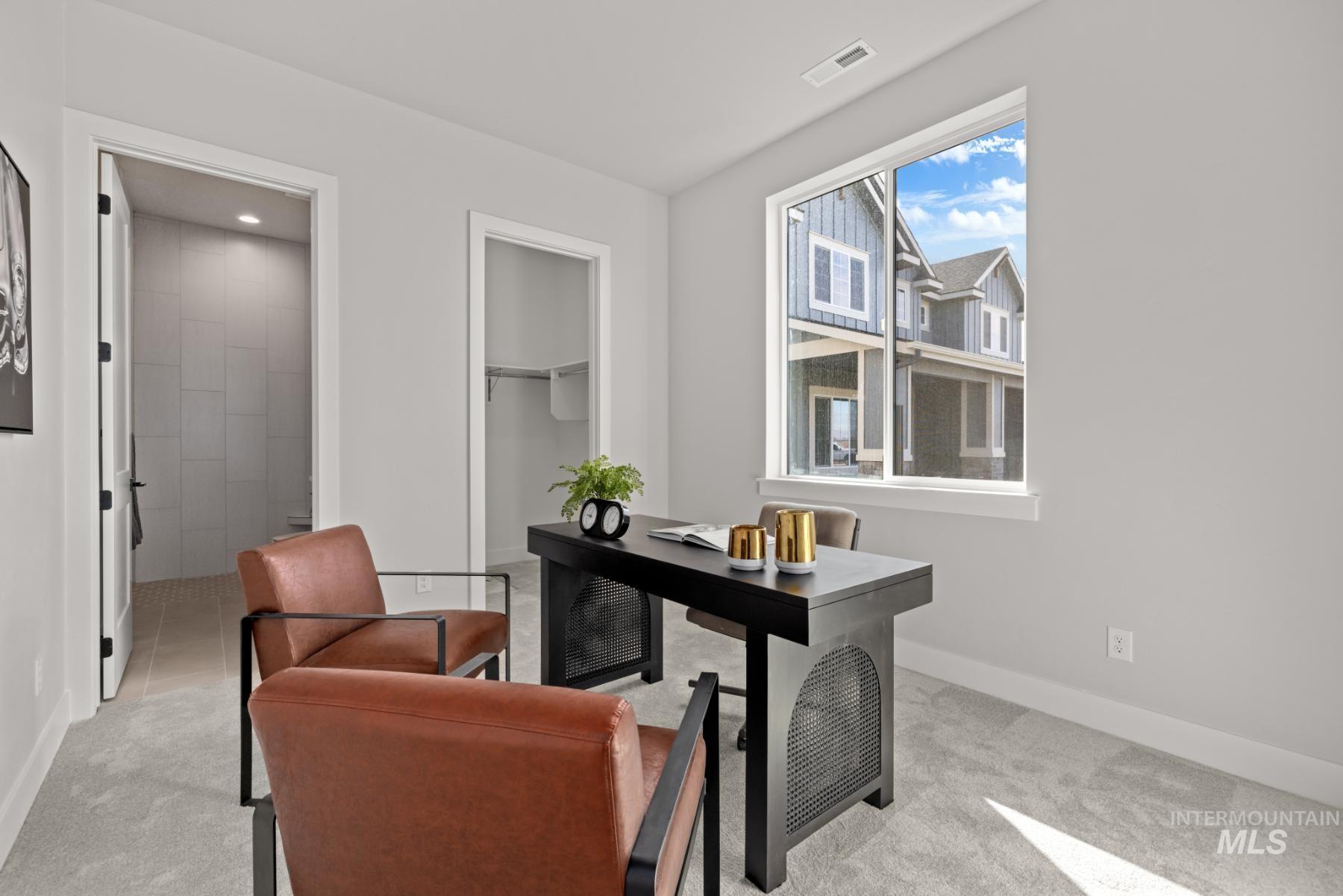 Home office with light carpet and recessed lighting