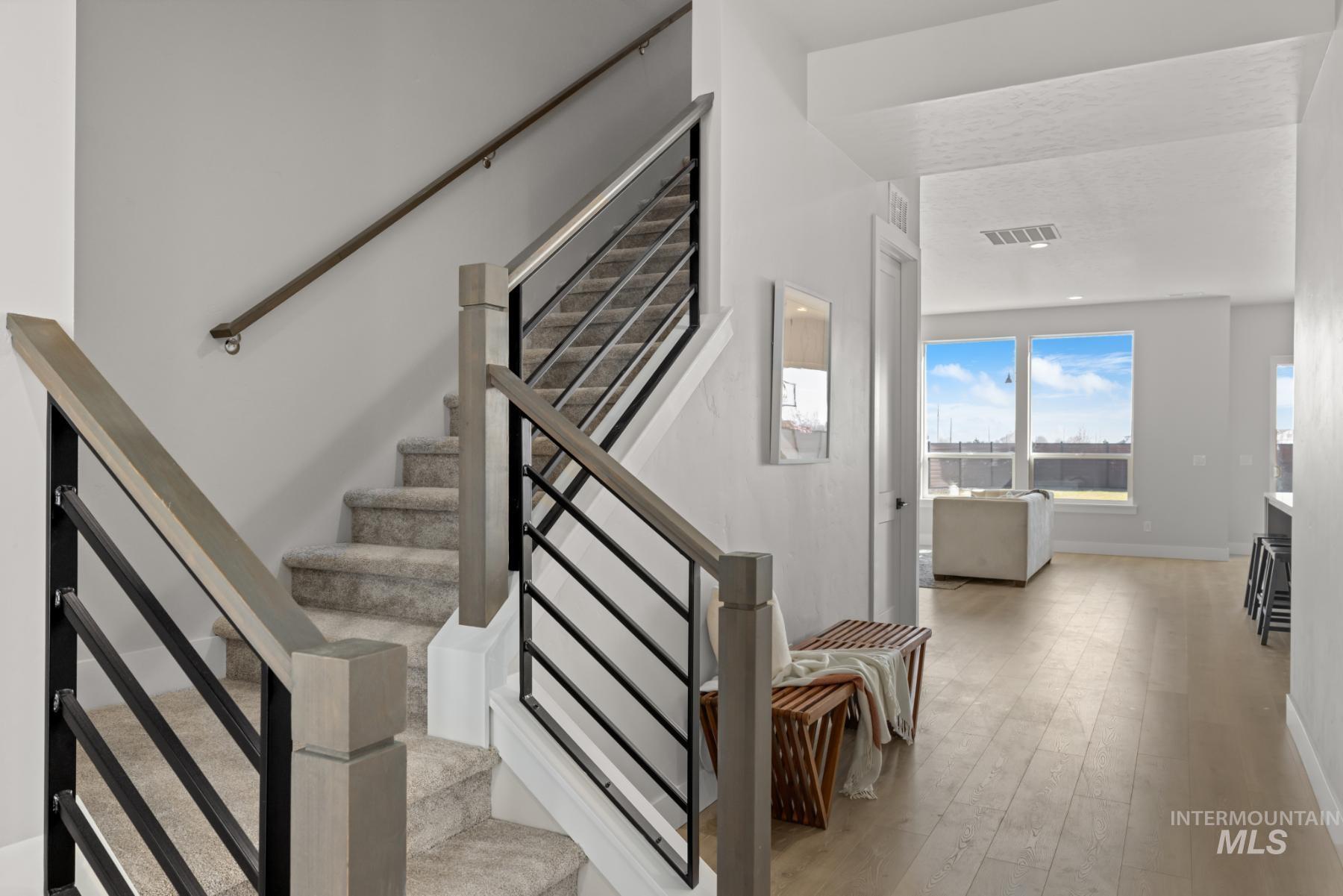 Staircase featuring wood finished floors and baseboards