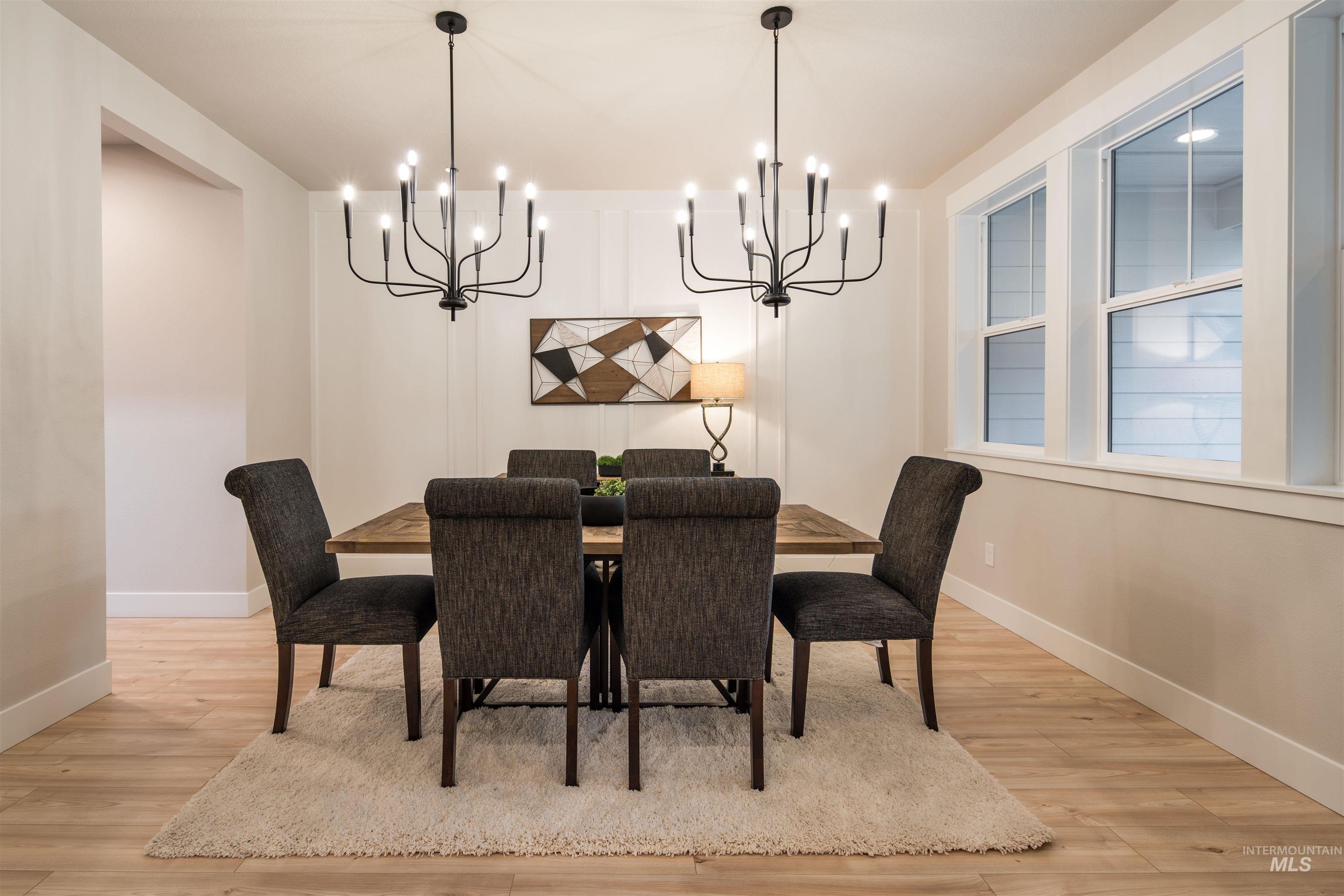 Dining area with light wood finished floors and a chandelier