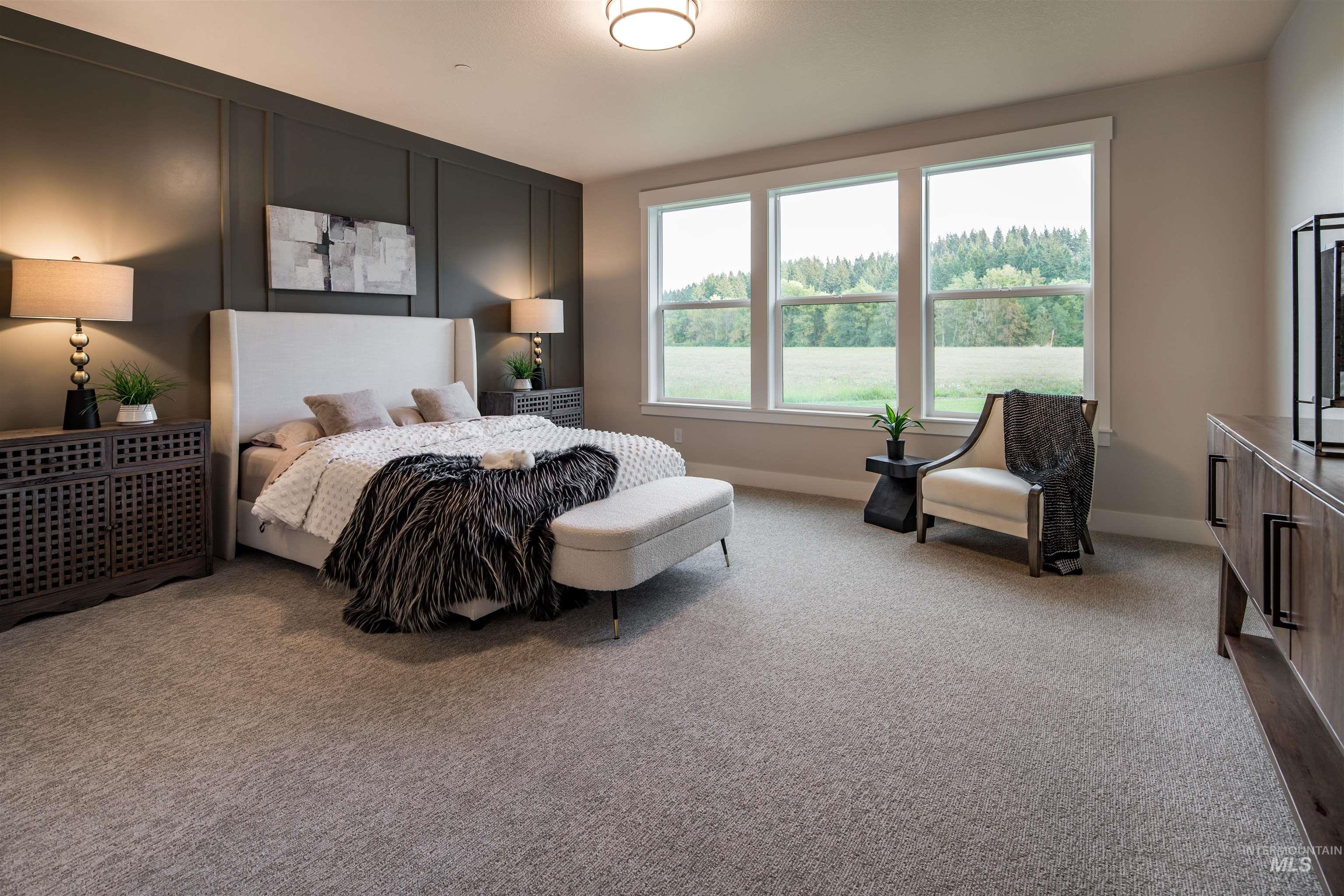 Carpeted bedroom featuring baseboards