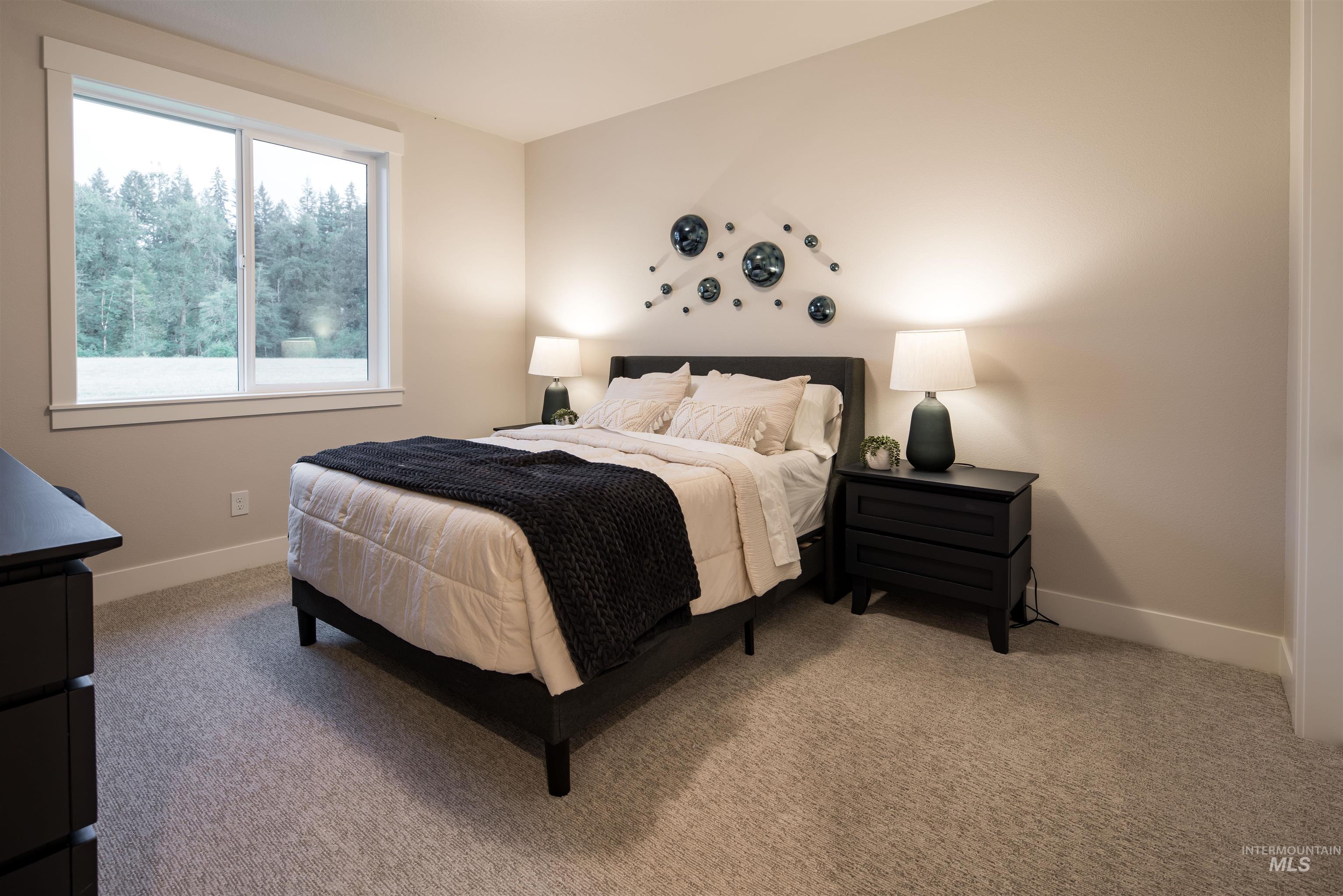 Carpeted bedroom with baseboards