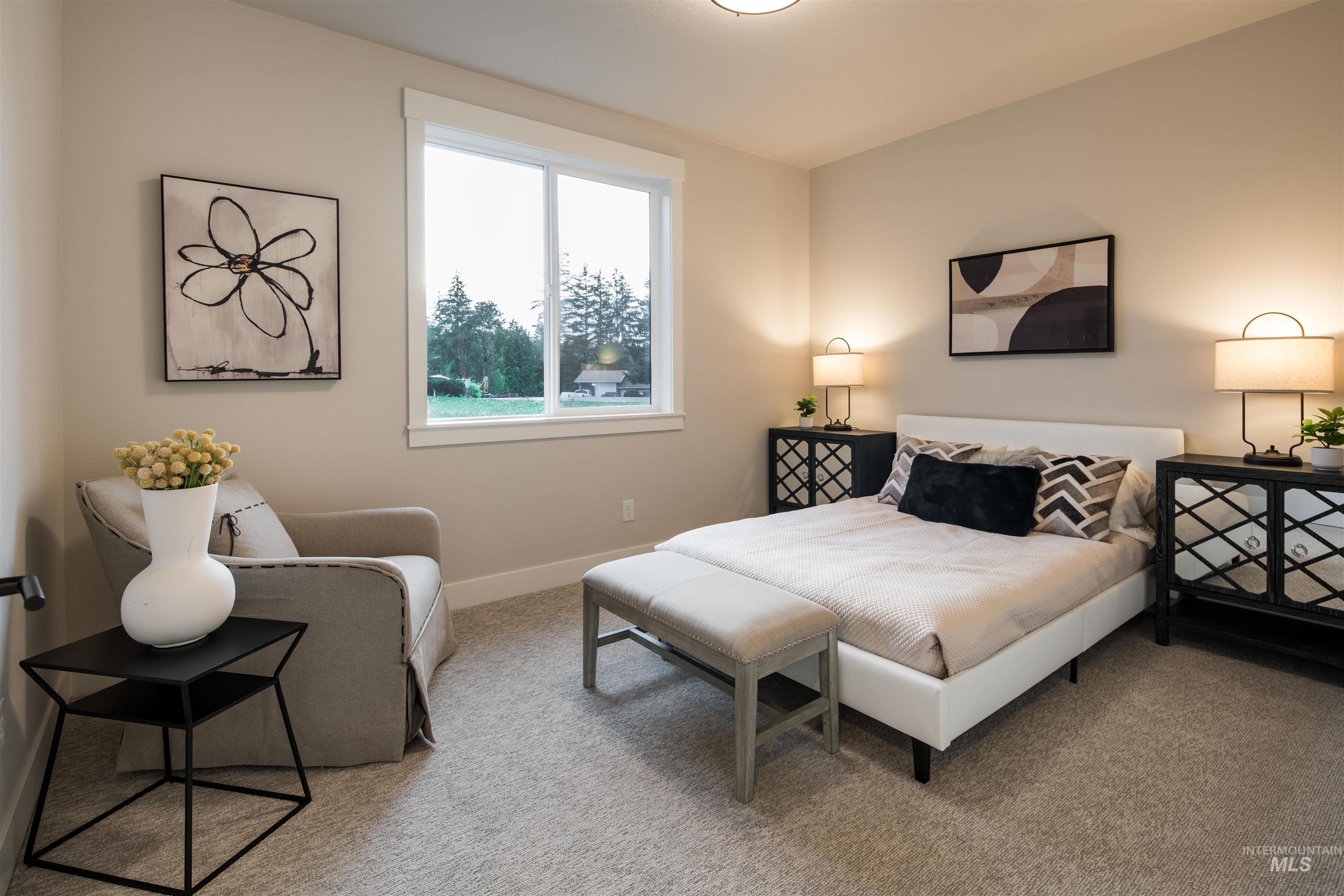 Bedroom featuring light colored carpet and baseboards