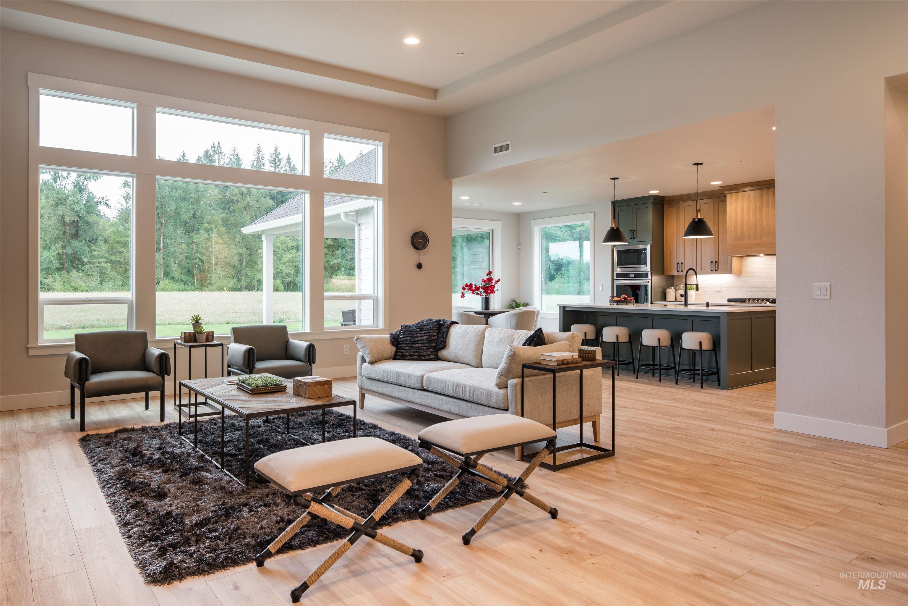 Living room with light wood-style floors and recessed lighting