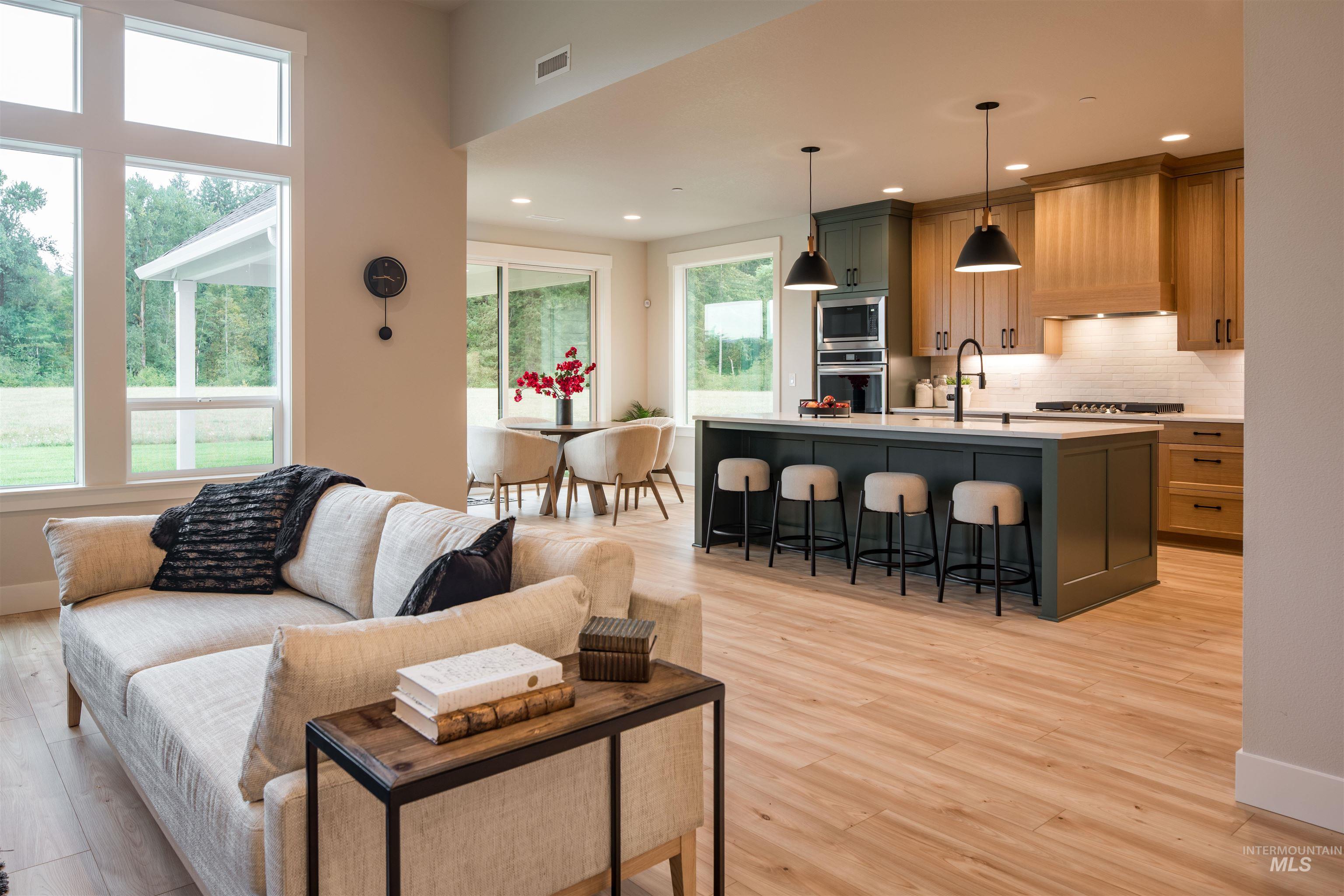 Living room with light wood-style floors and recessed lighting