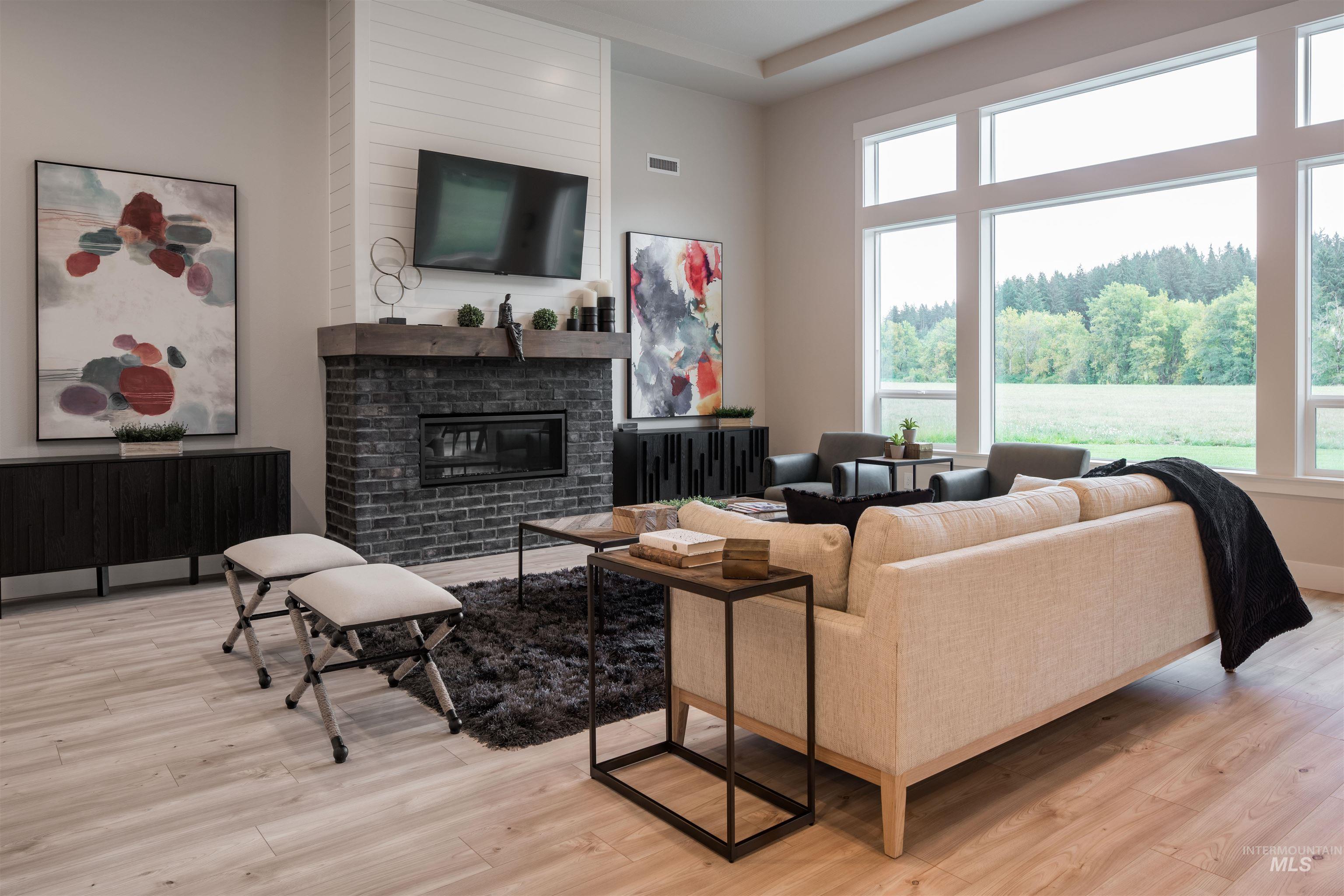 Living area with a fireplace and light wood-style floors
