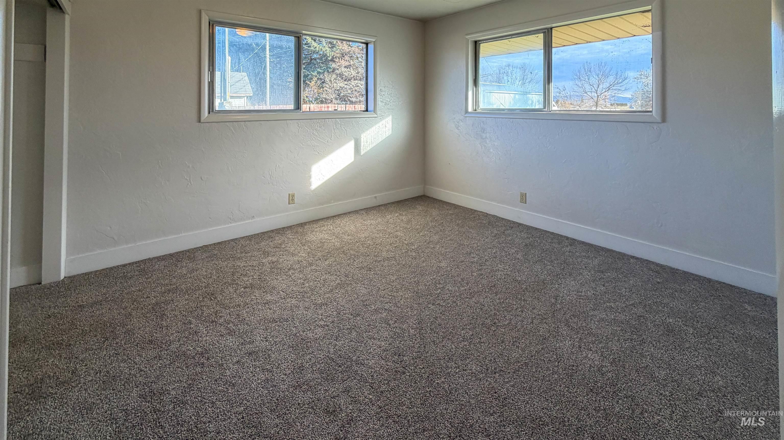 Unfurnished bedroom featuring carpet flooring and a textured wall