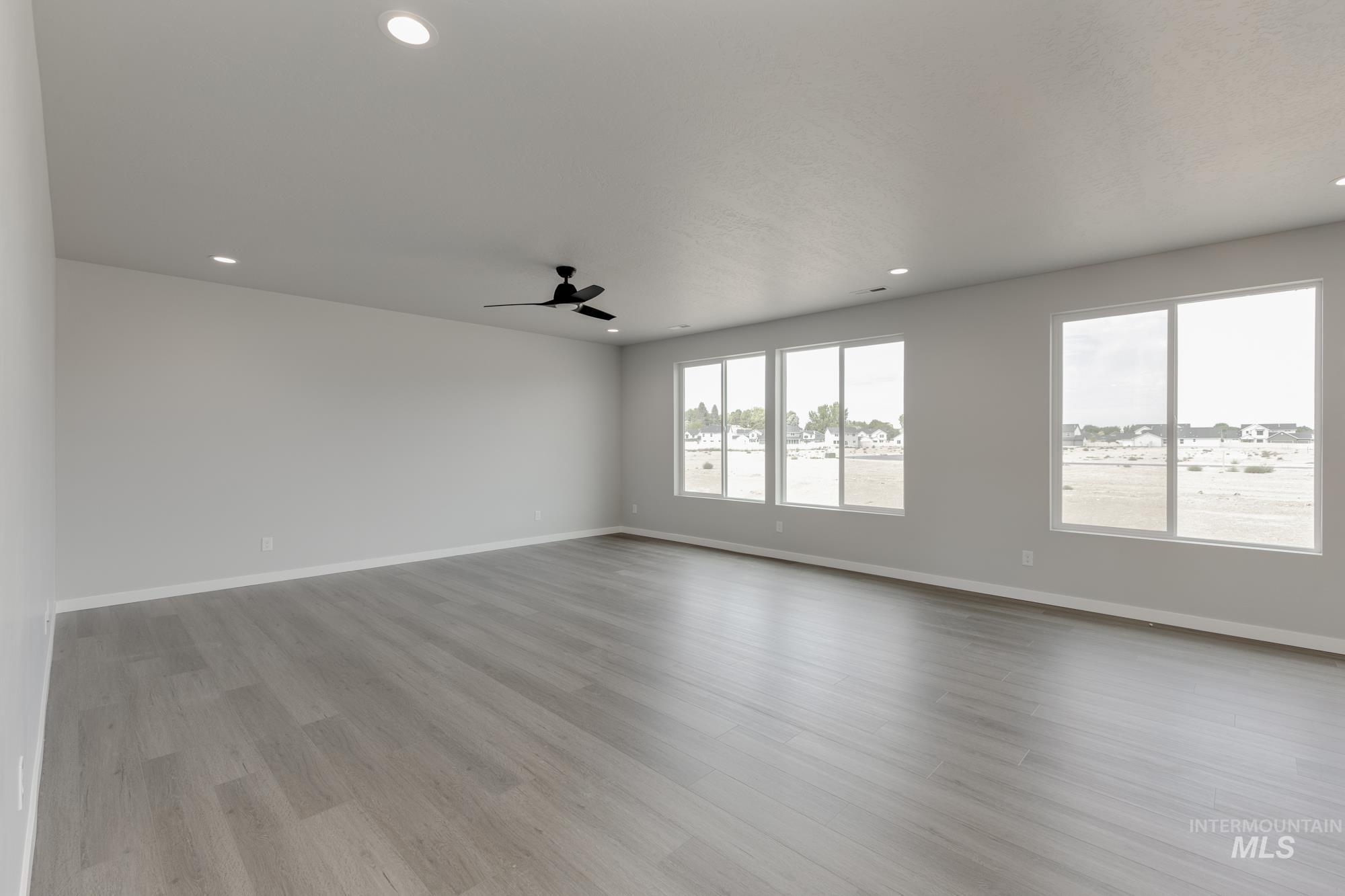 Empty room featuring light wood finished floors, recessed lighting, and a ceiling fan