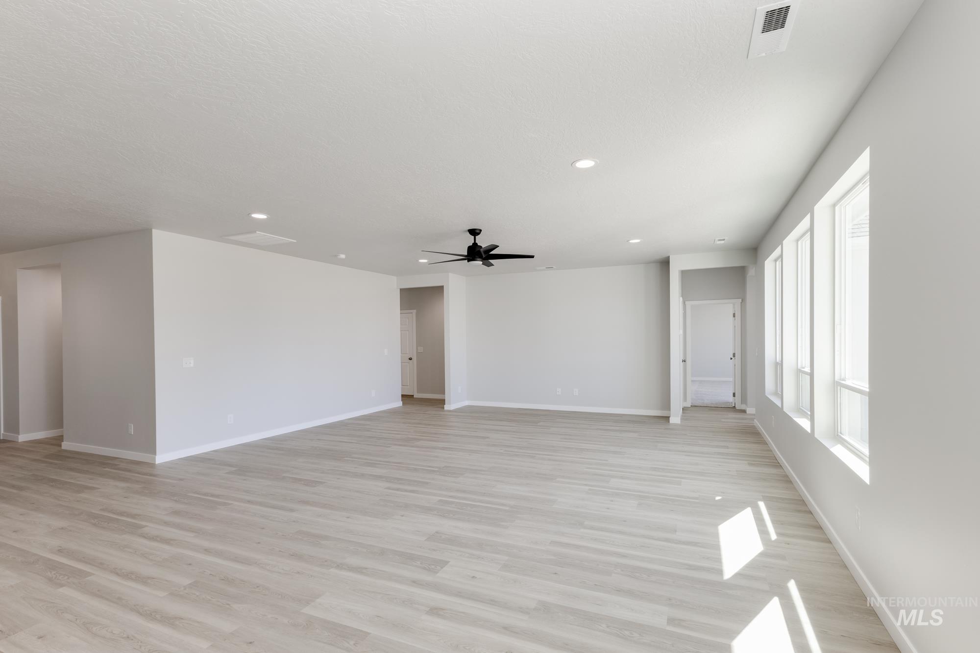 Unfurnished room with light wood-style floors, recessed lighting, and a ceiling fan