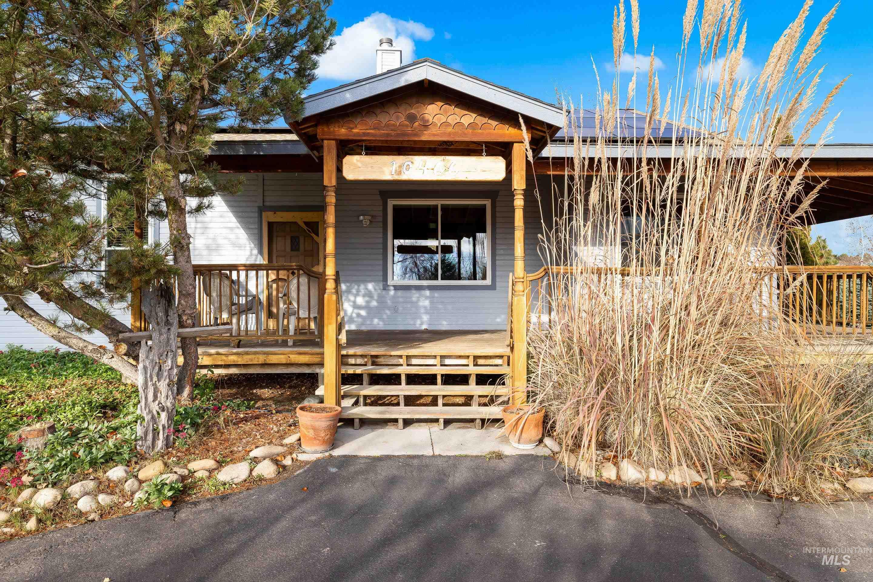 View of front of property featuring a chimney and a deck