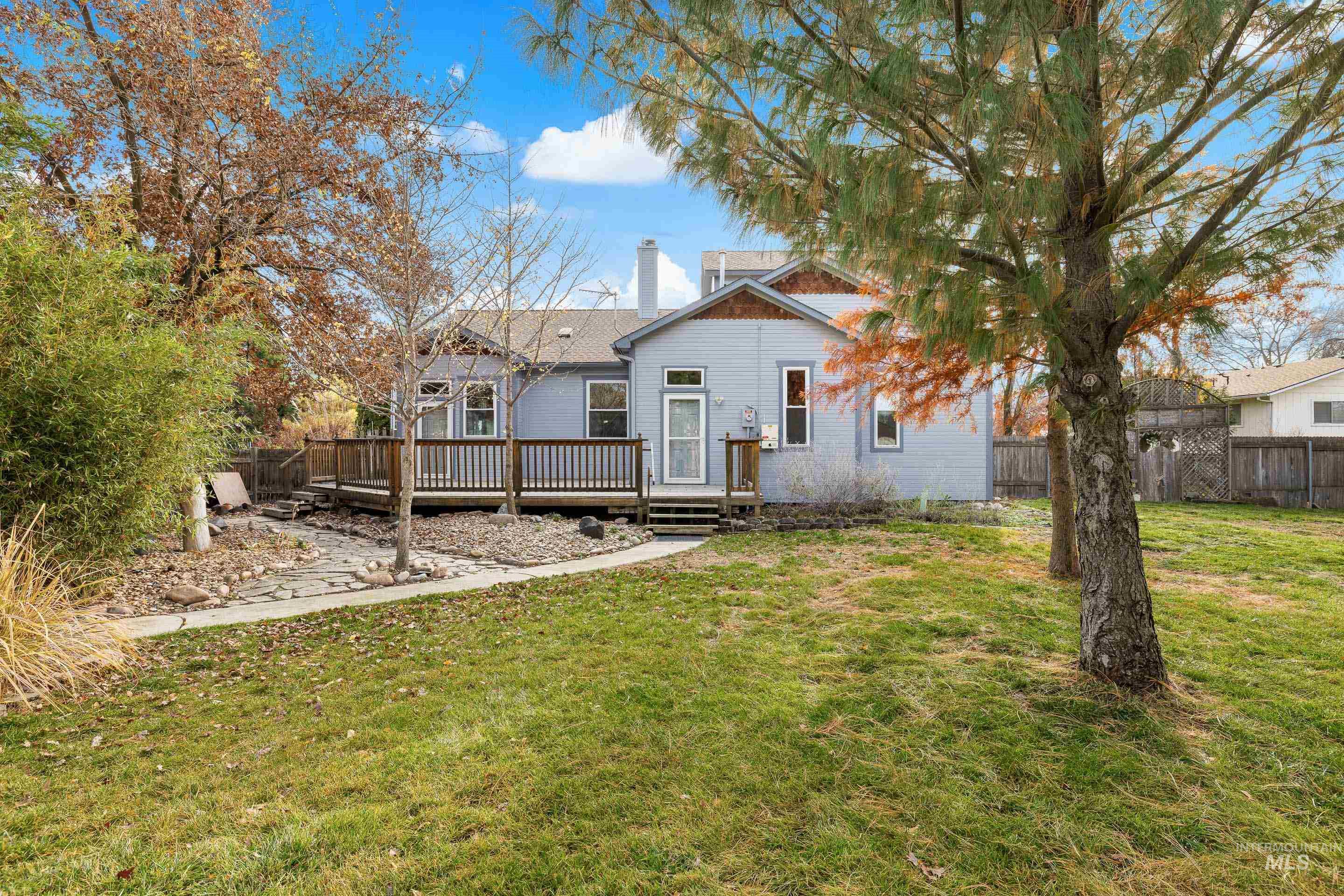 Rear view of property featuring a deck and a chimney