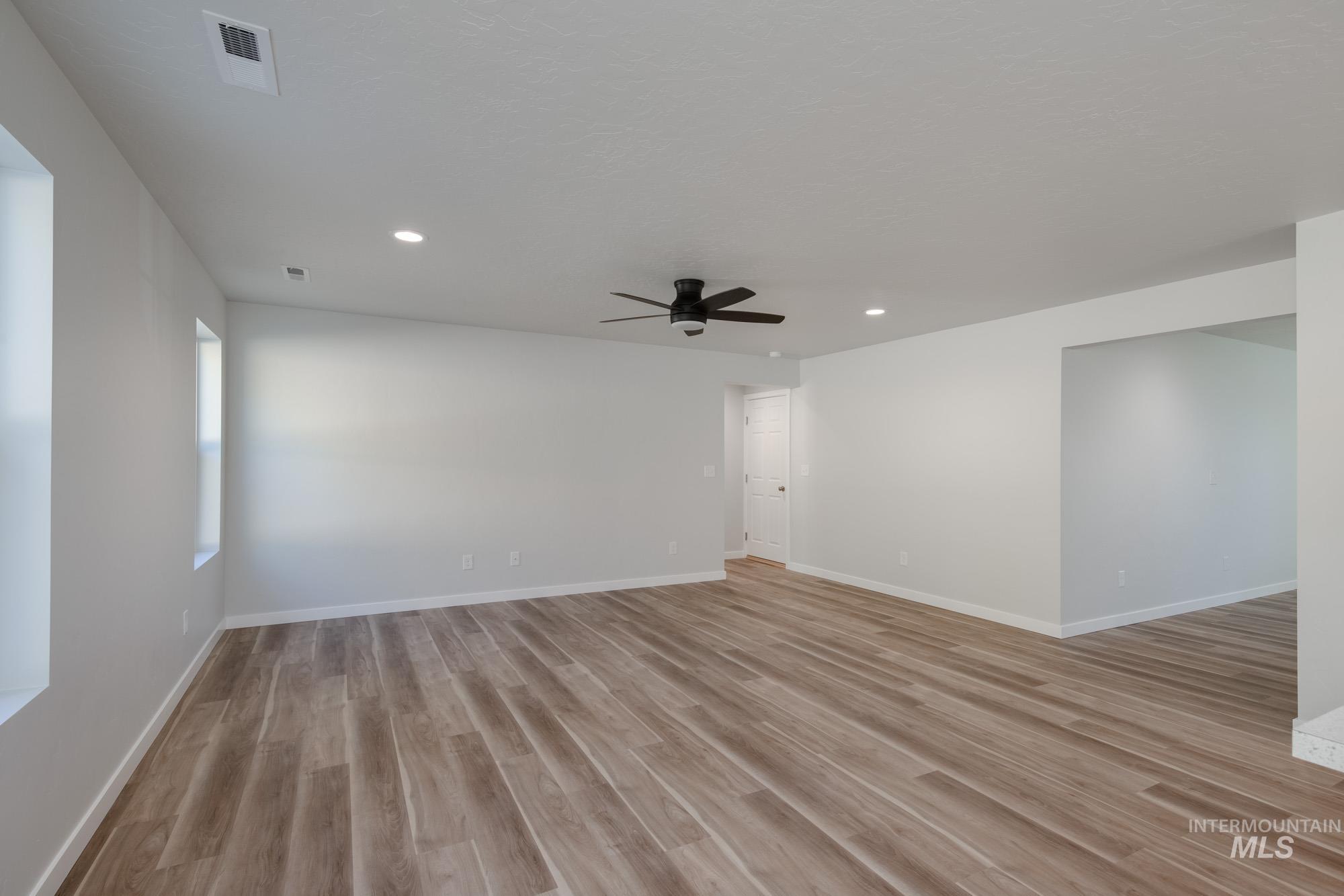 Spare room with light wood finished floors, recessed lighting, and ceiling fan