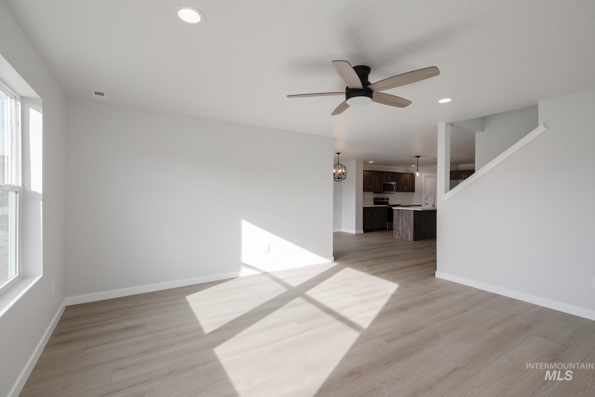 Unfurnished living room with recessed lighting, light wood finished floors, and ceiling fan