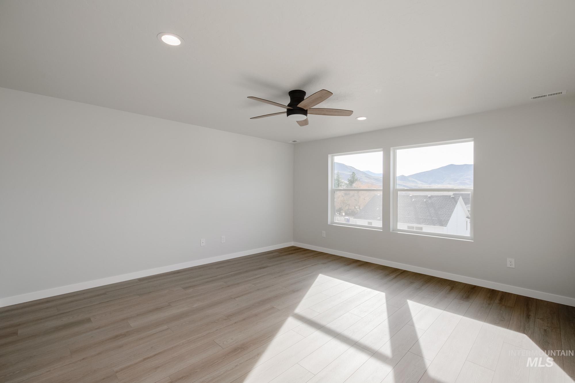 Empty room featuring recessed lighting, light wood-type flooring, and a ceiling fan