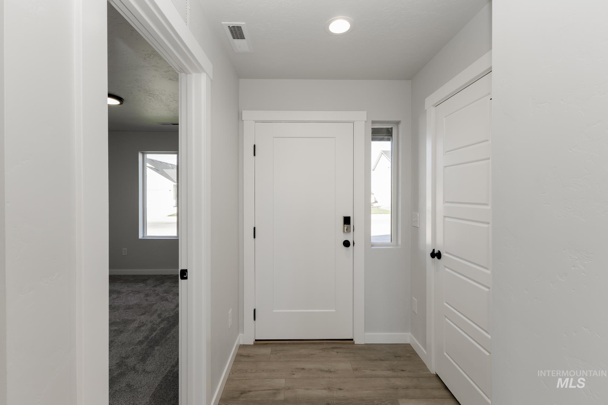 Entryway with plenty of natural light and light wood-style flooring