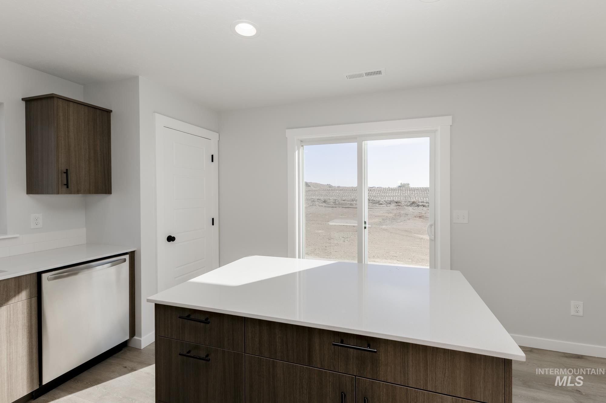 Kitchen featuring dark brown cabinets, dishwasher, light wood-style flooring, modern cabinets, and recessed lighting