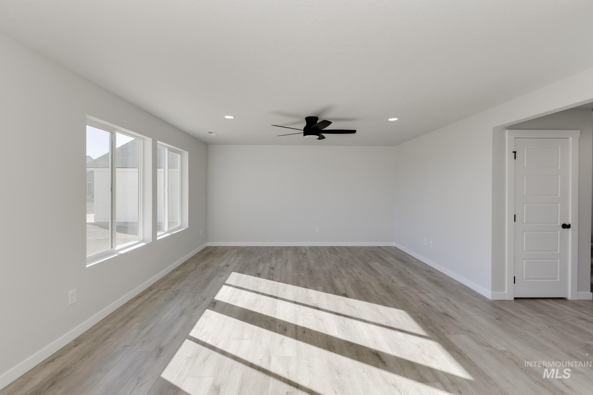 Unfurnished room with light wood-type flooring, recessed lighting, and ceiling fan