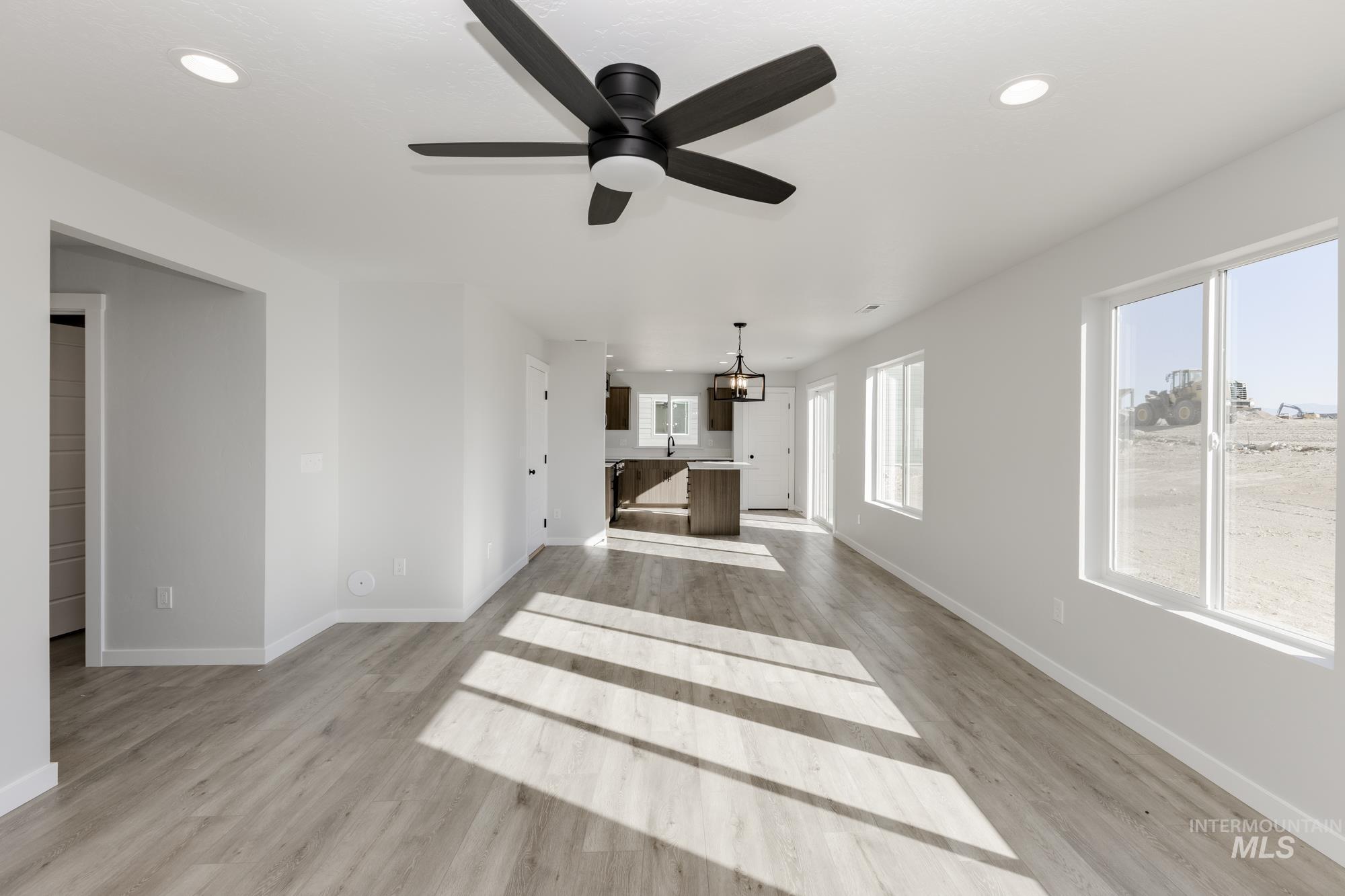 Unfurnished living room featuring recessed lighting, light wood finished floors, and a ceiling fan
